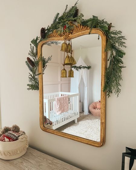 Girl nursery. Christmas decor. Christmas nursery. Toddler girl room. Kids room decor. Garland. Holiday decor. Board and batten wall. Holiday home decor. Gold mirror. Canopy. Crib. 

#LTKfamily #LTKGiftGuide #LTKHoliday