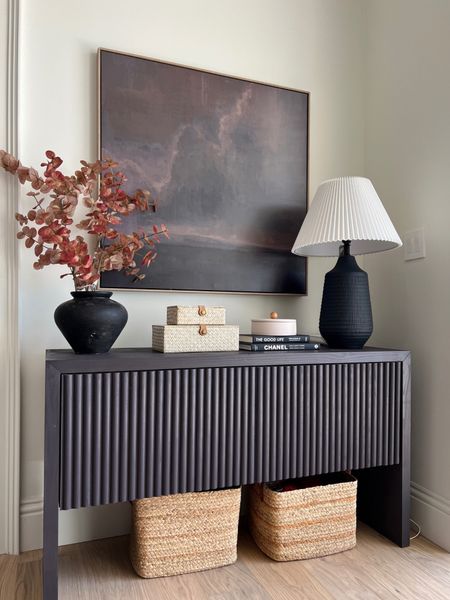 Console styling:

Tall Burgundy Eucalyptus Stem, Large Pleated Lamp Shade, Large Textured Ceramic Lamp, beaded Hyacinth Basket, Chanel coffee table book, wicker storage boxes. 

#LTKhome #LTKstyletip