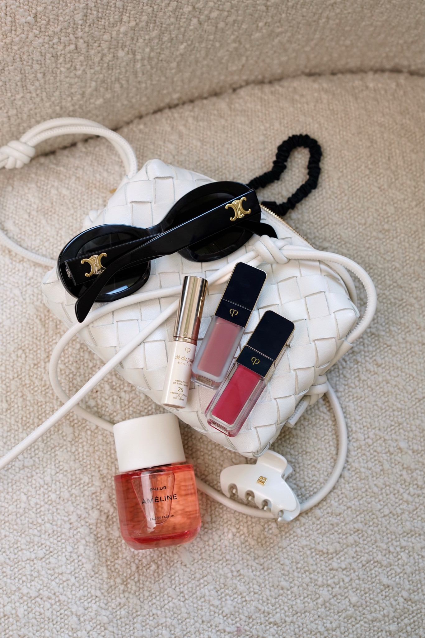 Weekend details mini Bottega Loop bag, Cle de Peau Cream Rouge Matte 111 & Shine 203, Phlur Ameline, Celine Oval Sunglasses