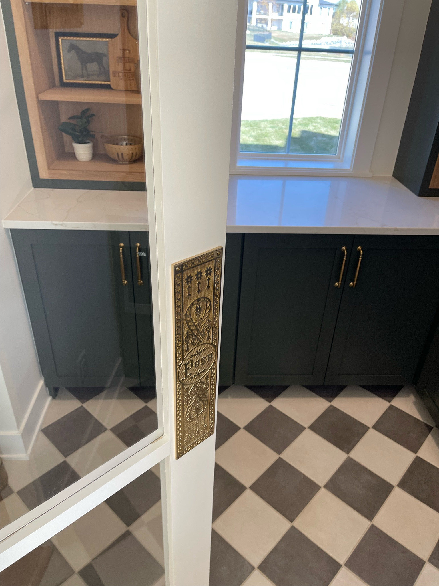 Kitchen Pantry // Swinging door on hinges with antique gold push plate //
Paint: Ripe Olive
Floors: The Tile Shop: Chalk white and chalk gray 
Custom Homes of Iowa // Husk Custom Homes 

#LTKSeasonal #LTKHome