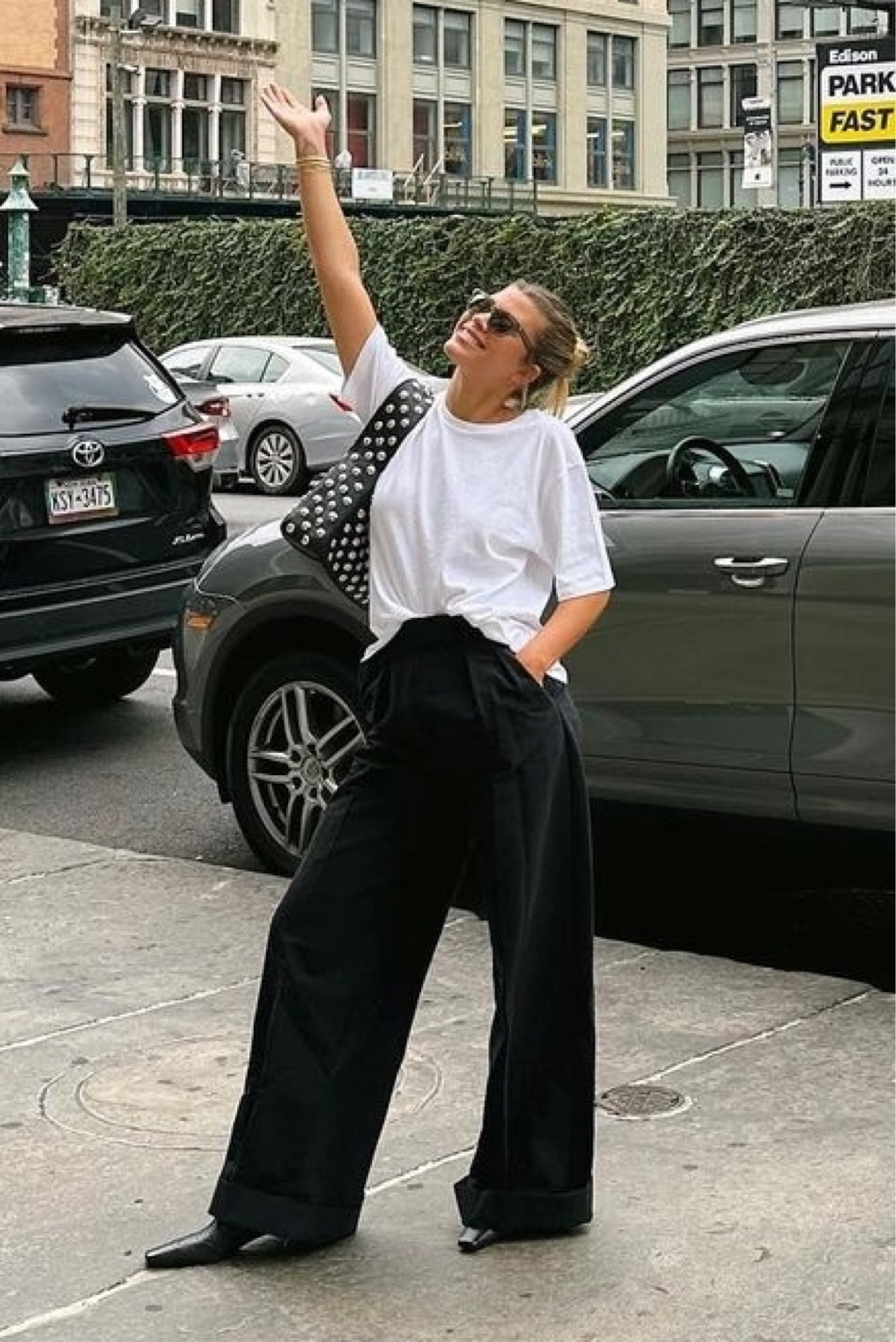 Shop Sofia Richie Grange's black wide leg pleated trousers, oversized white T-shirt, studded black shoulder bag, leather black ankle boots and light brown cat eye sunglasses


#LTKstyletip #LTKSeasonal