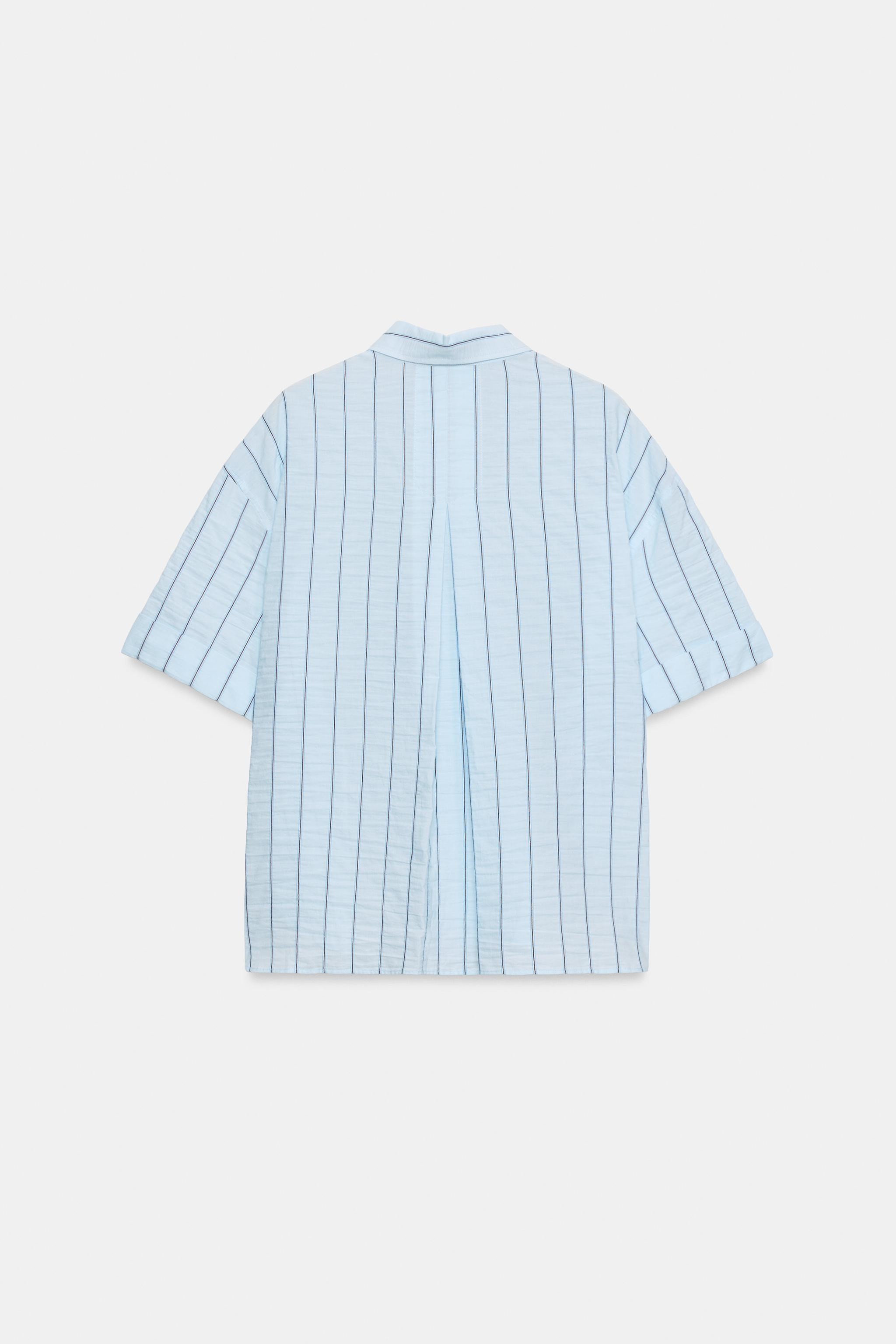 Model height: 181 cmOversize shirt with a regular collar and short sleeves with turn-ups. Featuri... | Zara UK