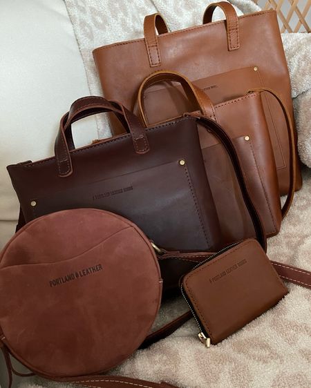 Portland Leather collection - from front to back:

- Circle Crossbody in small + mauve (color no longer available)
- Mini Crossbody Tote in cognac
- Mini Crossbody Tote in Honey
- Crossbody Tote in Honey
- Small Zip Wallet in Honey 