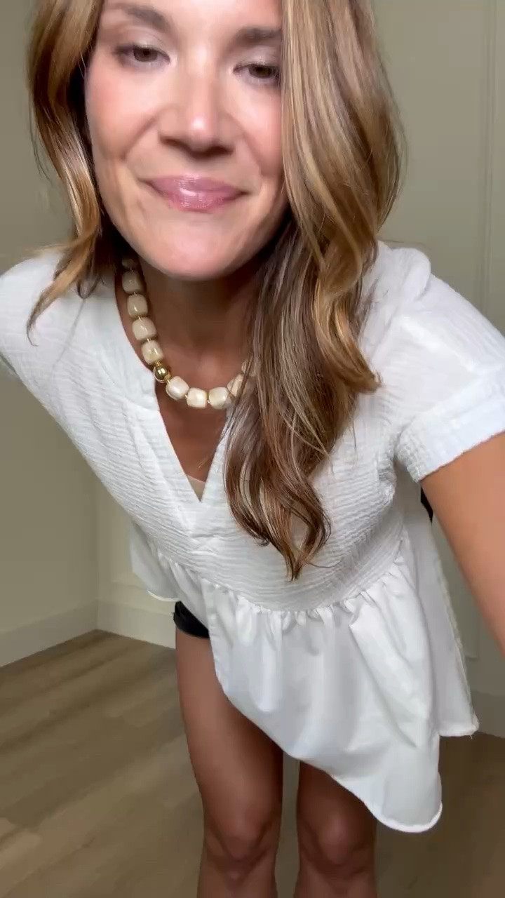 This white babydoll top has the prettiest flowy shape without overwhelming your frame. The V neckline keeps it flattering, while the soft fabric and slightly cropped length make it easy to pair with denim shorts, jeans, or trousers.

Size M

White babydoll top, flowy white blouse, summer top, black denim shorts, casual summer outfit, tall girl fashion, everyday style, feminine blouse, easy outfit idea, StangandCo

#LTKootd #LTKSeasonal #LTKTall