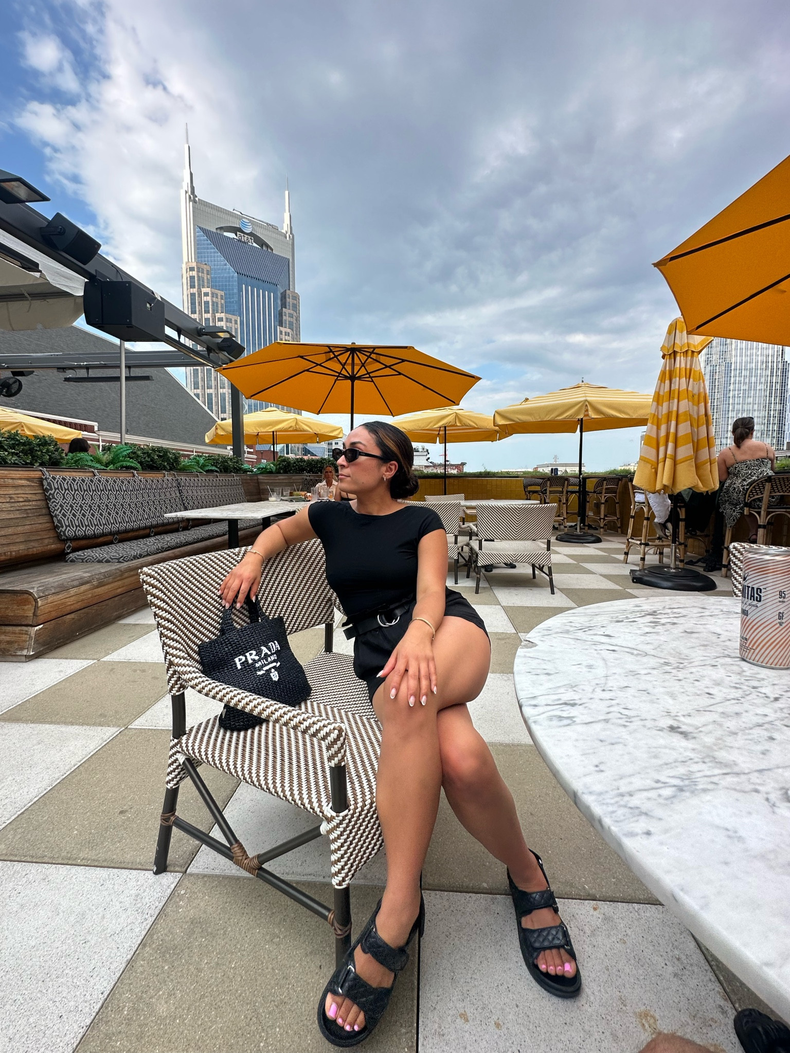 Cute and comfy outfit for Nashville. 7 for all man kind linen shorts with an Amazon backless top paired with sandals and my Prada summer bag.  