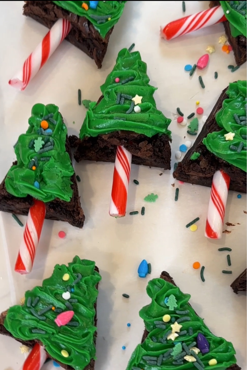 How cute are these Christmas tree brownies?! 🎄✨ Bake in an 8x8 dish, cut into three strips, and then into triangles. Add green icing, festive sprinkles, and a candy cane stick for the stump—it’s the perfect holiday treat! 🍫❤️ #HolidayBaking #ChristmasTreeBrownies #FestiveDesserts #HolidayTreat 

#LTKHoliday #LTKFamily #LTKSeasonal