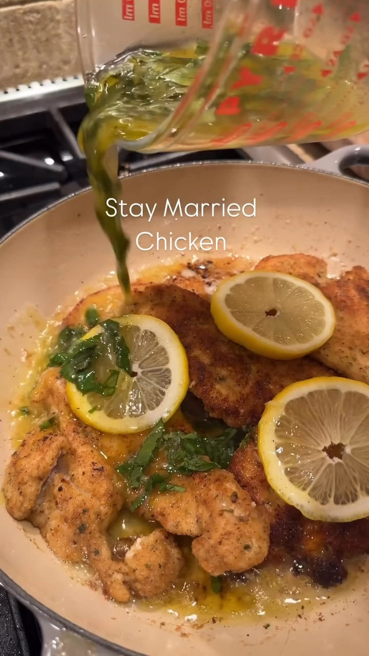 Leslie Stern’s Stay Married Chicken

Here’s what you’ll need:
1 lb of thinly sliced chicken breasts
1/3 cup half and half (to coat the chicken)
1 1/2 cups of seasoned breadcrumbs (Italian seasoning, garlic powder, salt and pepper)
Olive oil (enough to coat the bottom of the pan)
3 tbsp butter
4 slices of lemon

🍋Lemon Sauce:
Juice of 2 large lemons (or more if you like it saucy. It should be about a 1/2 cup of liquid)
*must be fresh lemon juice*
Equal parts olive oil (to the amount of lemon juice you have)
2 cloves of garlic, grated
A handful of fresh basil, roughly chopped
Salt, pepper, Italian seasoning and dash of paprika

Start by making the lemon sauce:
Combine the juice of two lemons, salt, pepper, Italian seasonings, grated garlic, and paprika into a measuring cup. 
Slowly whisk in an equal amount of olive oil until well combined. Add in freshly chopped basil. Stir and set aside.

1. Preheat the oven to 325.
2. Thinly slice the chicken breasts and season with salt, pepper and Italian seasonings.
3. Add the chicken to a bowl and pour over the half and half until evenly coated.
*I use half and half in substitution for an egg. This will help the breadcrumbs stick to the chicken.
4. Dip the chicken breasts into the breadcrumb mixture, coating all sides of the chicken.
5. Heat an oven safe pan on medium with olive oil and butter.
6. Cook the chicken on each side until golden brown. (The chicken does not need to be fully cooked through, as it will finish cooking in the oven). About 3-4 minutes, per side. 
7. Remove the browned chicken and place on a paper towel lined plate. Repeat until all of the chicken has been cooked. 
8. Once all the cutlets are browned, add the chicken back into the hot pan, top with sliced lemon and pour the lemon sauce over the chicken. Let bubble for 2 minutes. 
9. Bake in the oven for 12-18 minutes until bubbling and all of the chicken is fully cooked through and golden brown.
10. Keep warm at 200 until ready to serve. Serve and top with the lemon sauce from the pan. 
