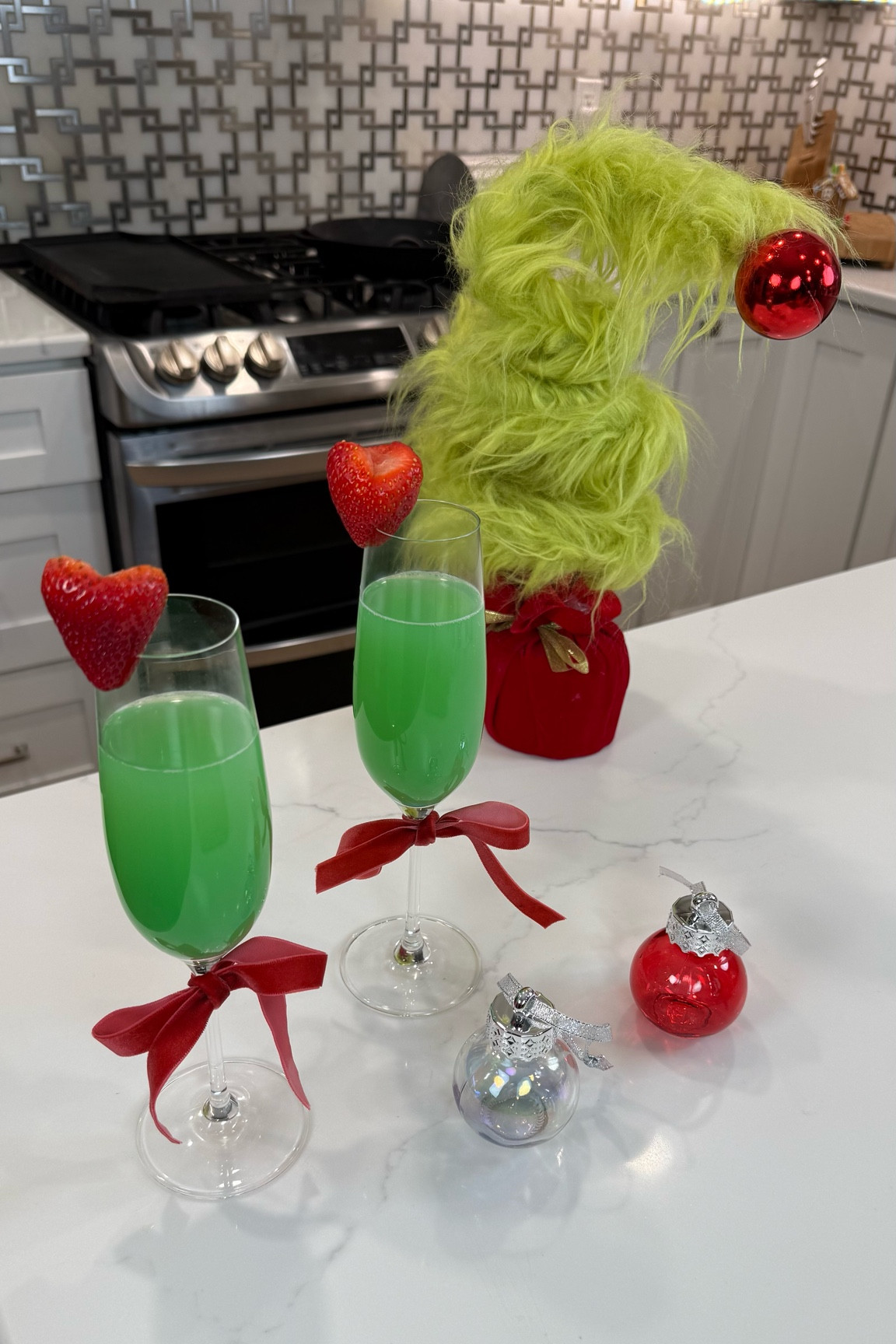 Make your holiday parties extra fun with these Grinch Mimosas! 💚✨ Perfect for both adults and kids—just swap the champagne for sparkling apple cider to make it kid-friendly! Start with a splash of blue curaçao, fill ornament shot glasses with orange juice, and place them on top of your cups. When it’s time to serve, pour the ornament in and watch the magic as the drink turns Grinchy green! Top with bubbly or sparkling cider for the perfect festive touch!

#GrinchMimosas #HolidayDrinks #FestiveCocktails #KidFriendlyDrinks #HolidayEntertaining #LTKHoliday #ChristmasRecipes #HolidayPartyIdeas

#LTKHoliday #LTKHome #LTKParties