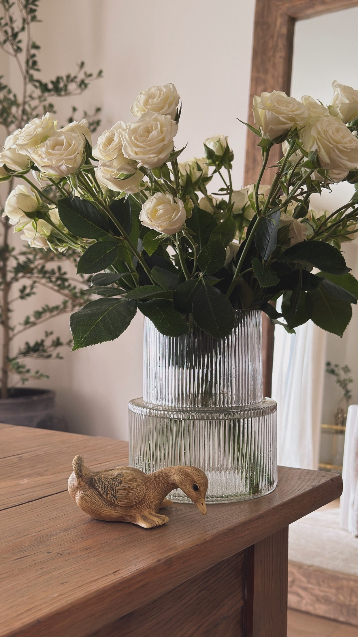 Little duck I found at an antique store, fresh Trader Joe’s flowers, my favorite reclaimed wood mirror and this fluted vase that looks expensive but it’s Amazon 🤎

#LTKHome #LTKdayinmylife #LTKSaleAlert