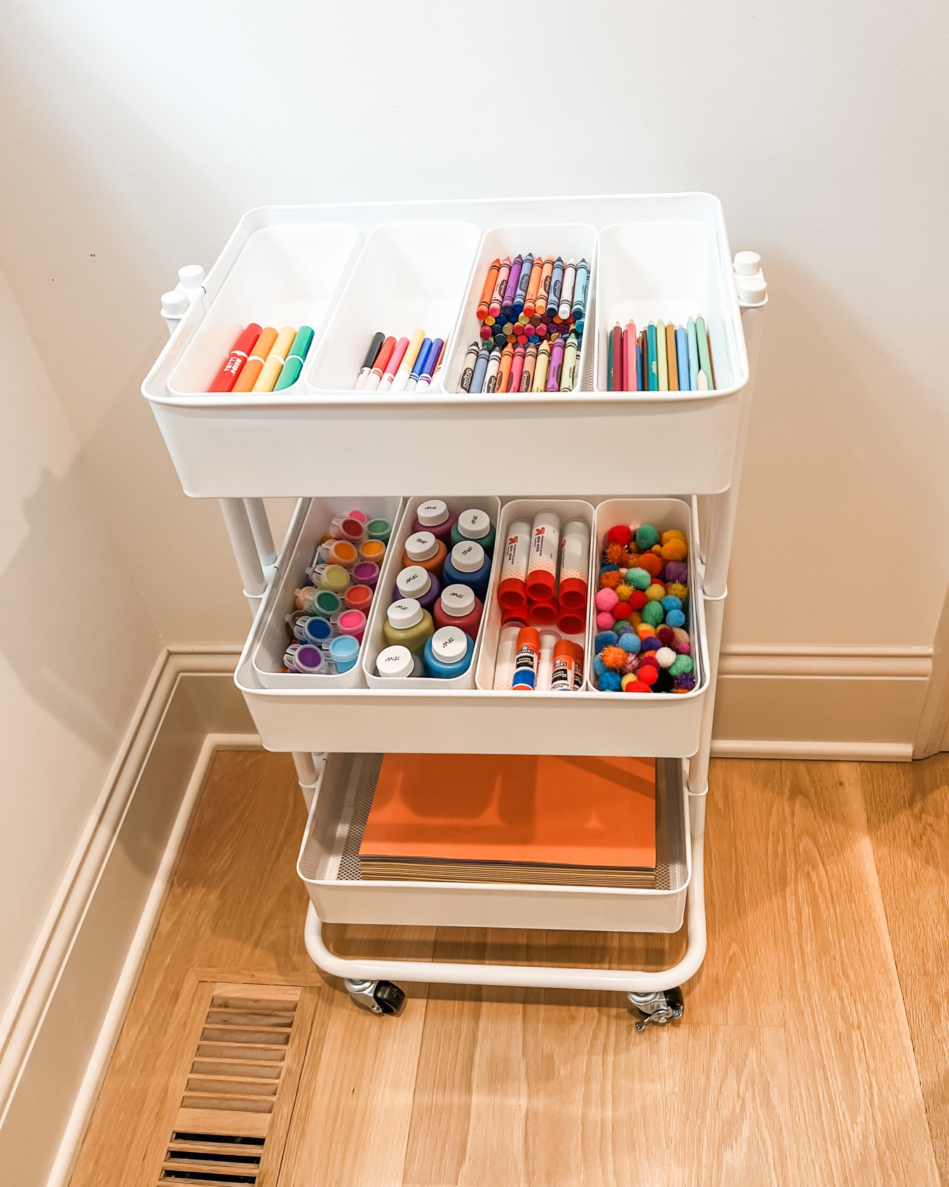 Kids love crafts and parents love organization and, believe it or not, those two things can go together! Enter the three-tiered craft cart. Bonus - it has wheels and can be moved around your house wherever your little artist sees fit to create! 

 