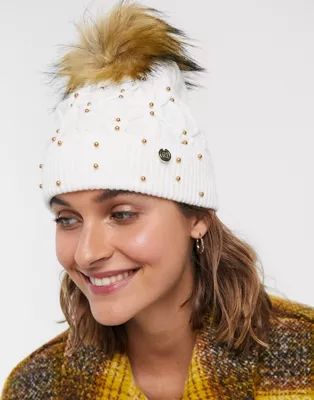 River Island cable knitted beanie hat with studs and faux fur pom pom in cream | ASOS UK