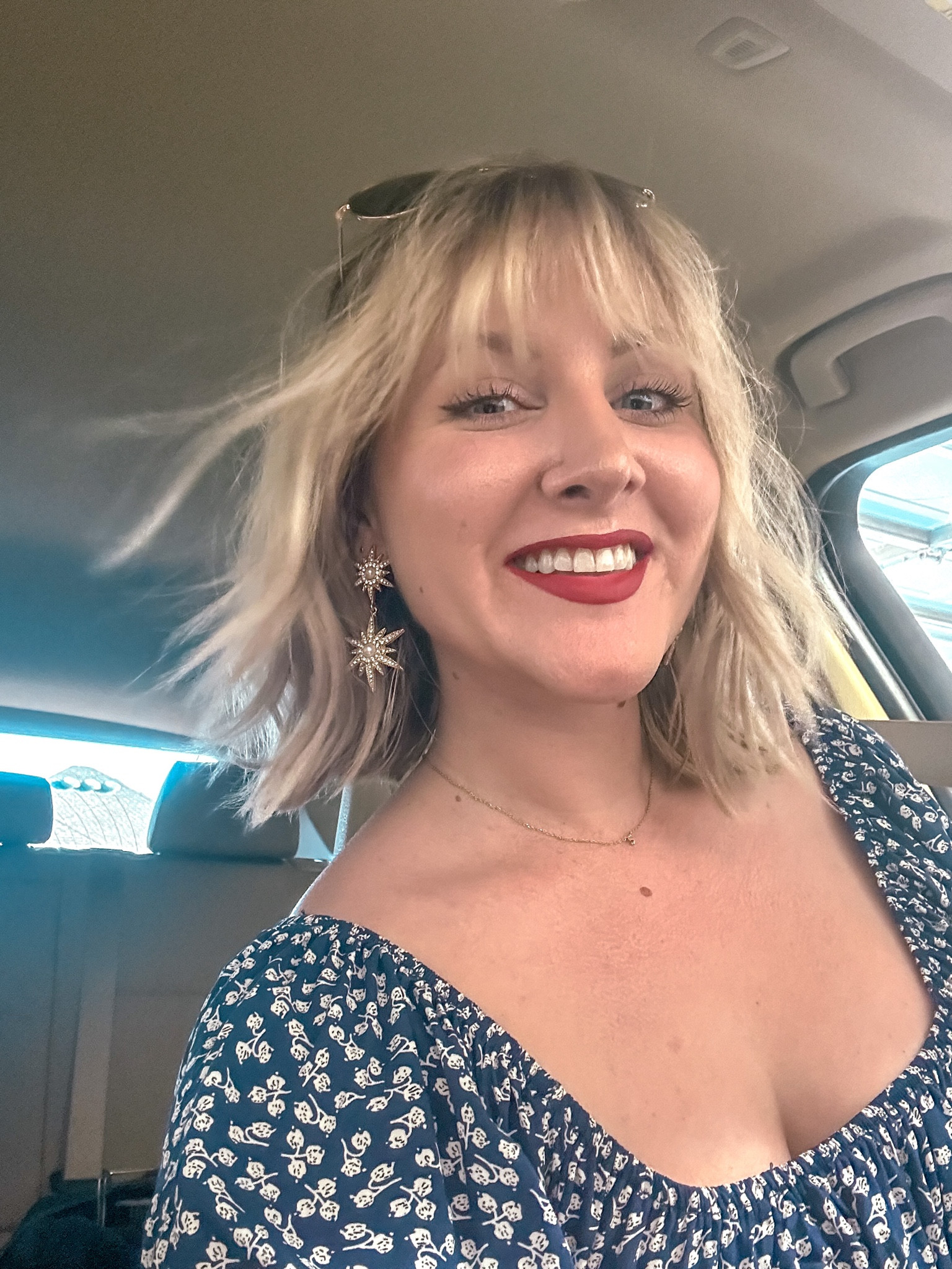 Cute outfit idea for 4th of July, starburst earrings for fireworks, bright red smudgeproof Fenty lipstick, and navy and white two piece set with cropped, puff sleeve wrap top and high-waist skirt. 

#LTKstyletip #LTKunder50 #LTKSeasonal