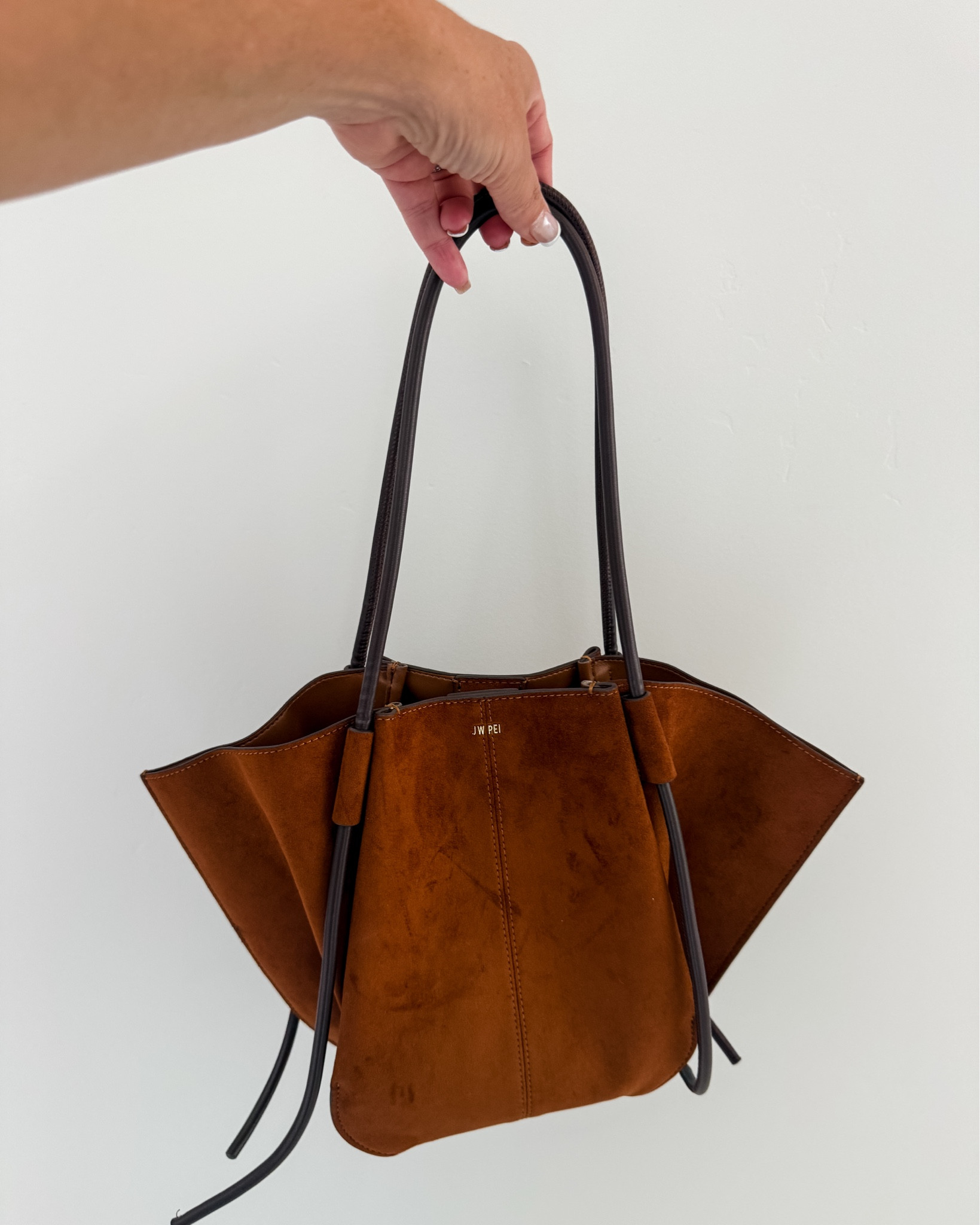This bag is so good for fall because it has that lighter cognac "toffee" color AND a darker espresso handles and honestly it's smaller than I expected but makes it so much easier to carry!

#LTKSeasonal #LTKMidsize #LTKWorkwear