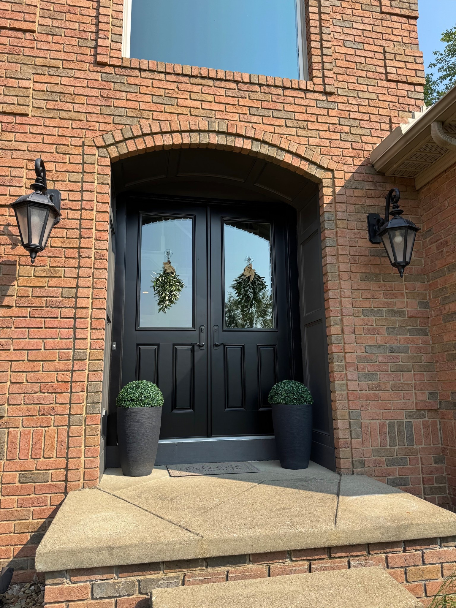 Front door decor. Faux boxwood plants. Planters. Front porch decor. Home decor. Front door. Black front door. Faux olive wreath 

#LTKHome #LTKSummerEdit