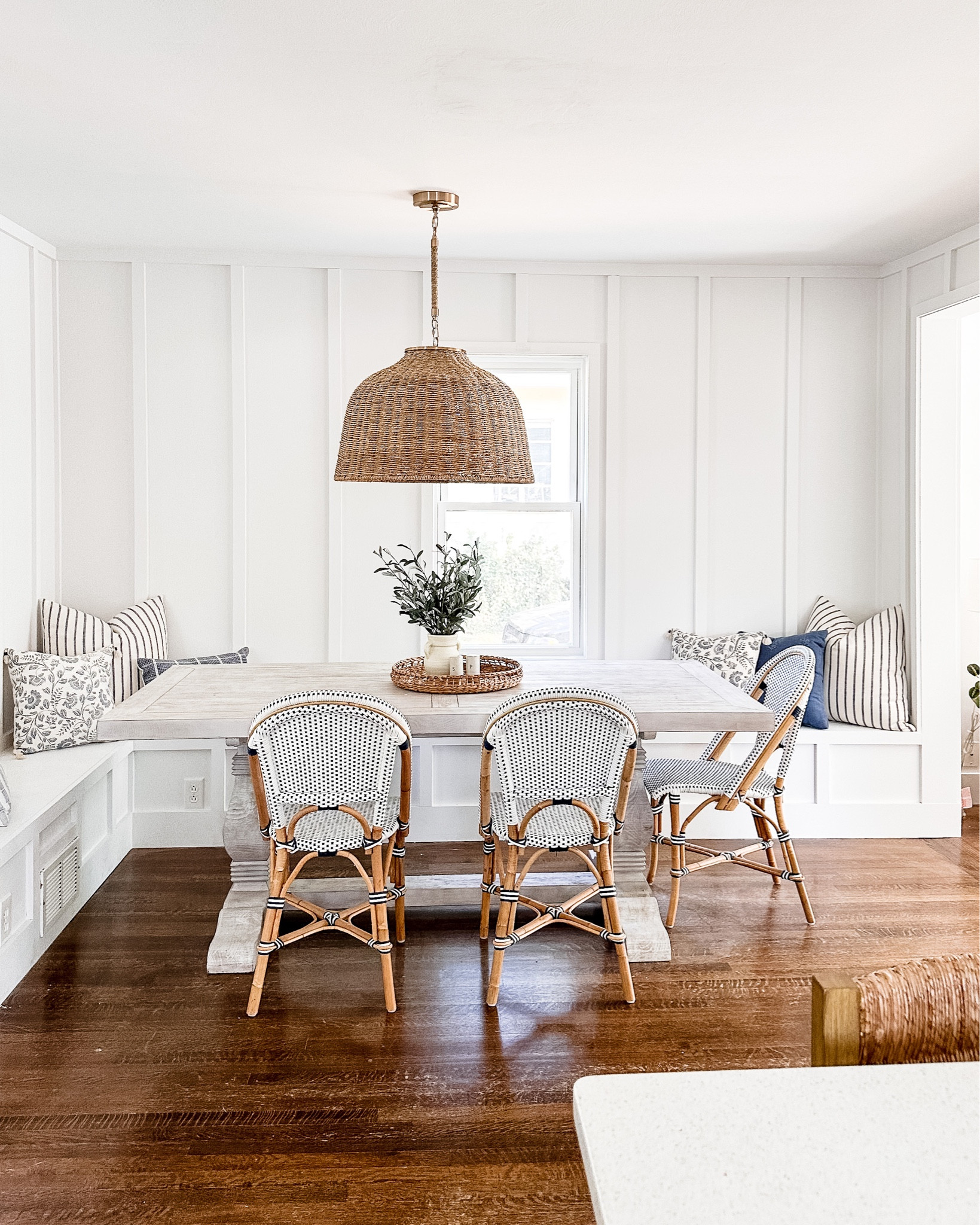 Breakfast Nook details at the Guest Cottage🤍

~~~~~
Blue and white decor, kitchen furniture, white trestle table, banquette seating, woven light fixture, rattan pendant lighting, studio mcgee chandelier, french bistro dining chairs, throw pillow, serena and lily#LTKunder50

#LTKhome #LTKsalealert