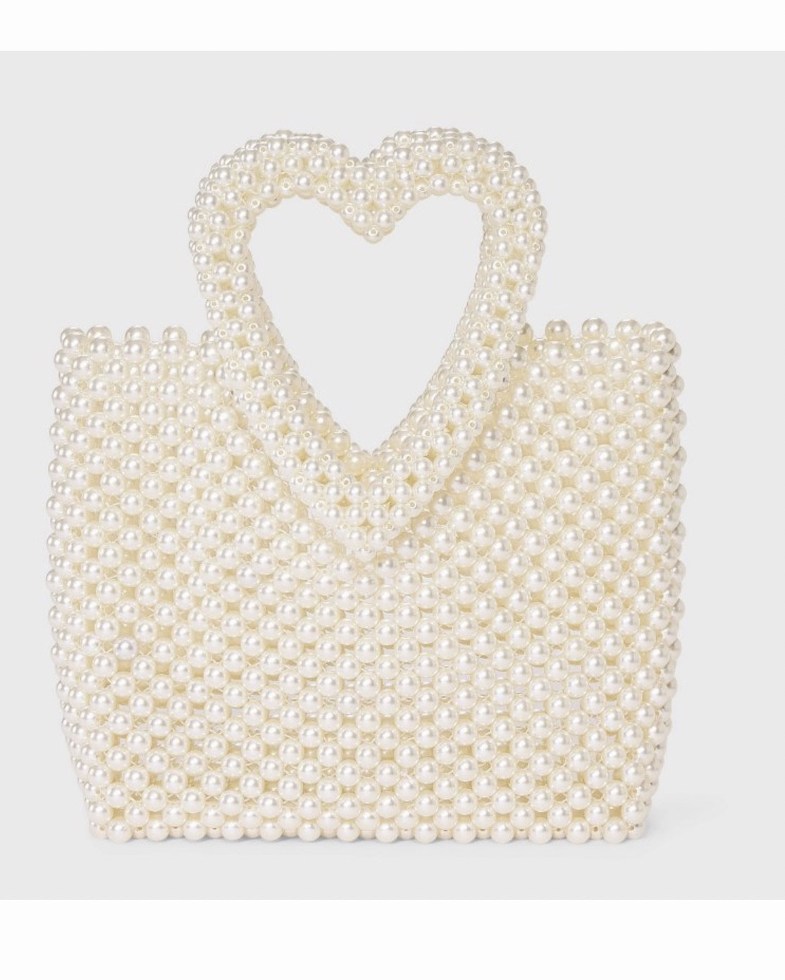 Simulated Pearl Heart Beaded Mini Tote Handbag - A New Day™ Cream
Valentine’s Day Bag
• Mini tote handbag with simulated pearl beads
• Heart-shaped double handles
• Hardside woven design
• Open main compartment
• Plastic shell
Product details
Bring a sweet, standout touch to your look with this Simulated Pearl Heart Beaded Mini Tote Handbag from A New Day™. This cream hardside tote bag is crafted with a woven design made from simulated pearl beads, giving it a playful, eye-catching texture. The heart-shaped handles add a charming finish, while the open main compartment offers ample space for your on-the-go essentials.
A New Day™: Style that goes wherever you do.

#LTKWedding #LTKFindsUnder50 #LTKSeasonal