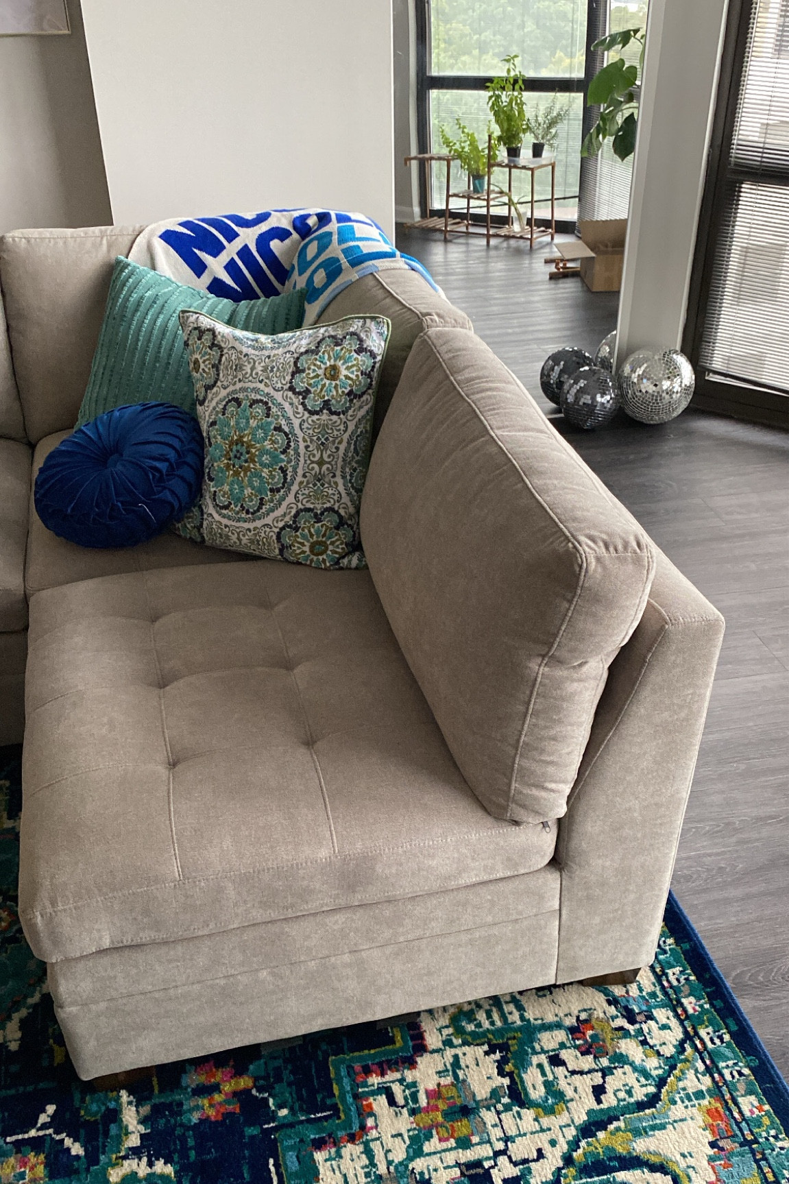 A look inside my living room! I have a modular sectional couch and I’m loving the disco balls in my windows 🤩 // colorful area rug, blue area rug, green area rug, turquoise rug, velvet throw pillows, monogram blanket, personalized blanket

#LTKhome #LTKunder100 #LTKunder50