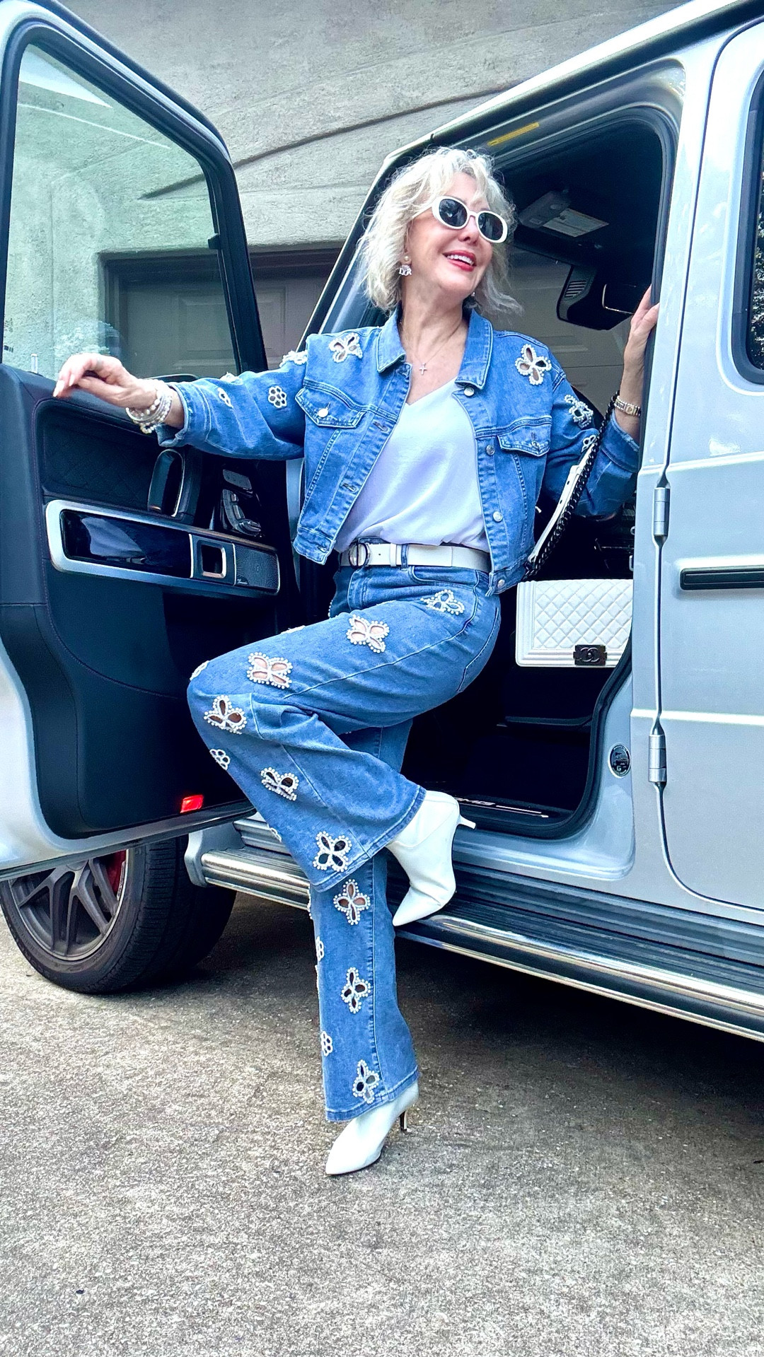 Denim jeans and jacket with white floral embroidery and pearl accents.
White booties
White classic bag 

#LTKParties #LTKStyleTip #LTKOver40