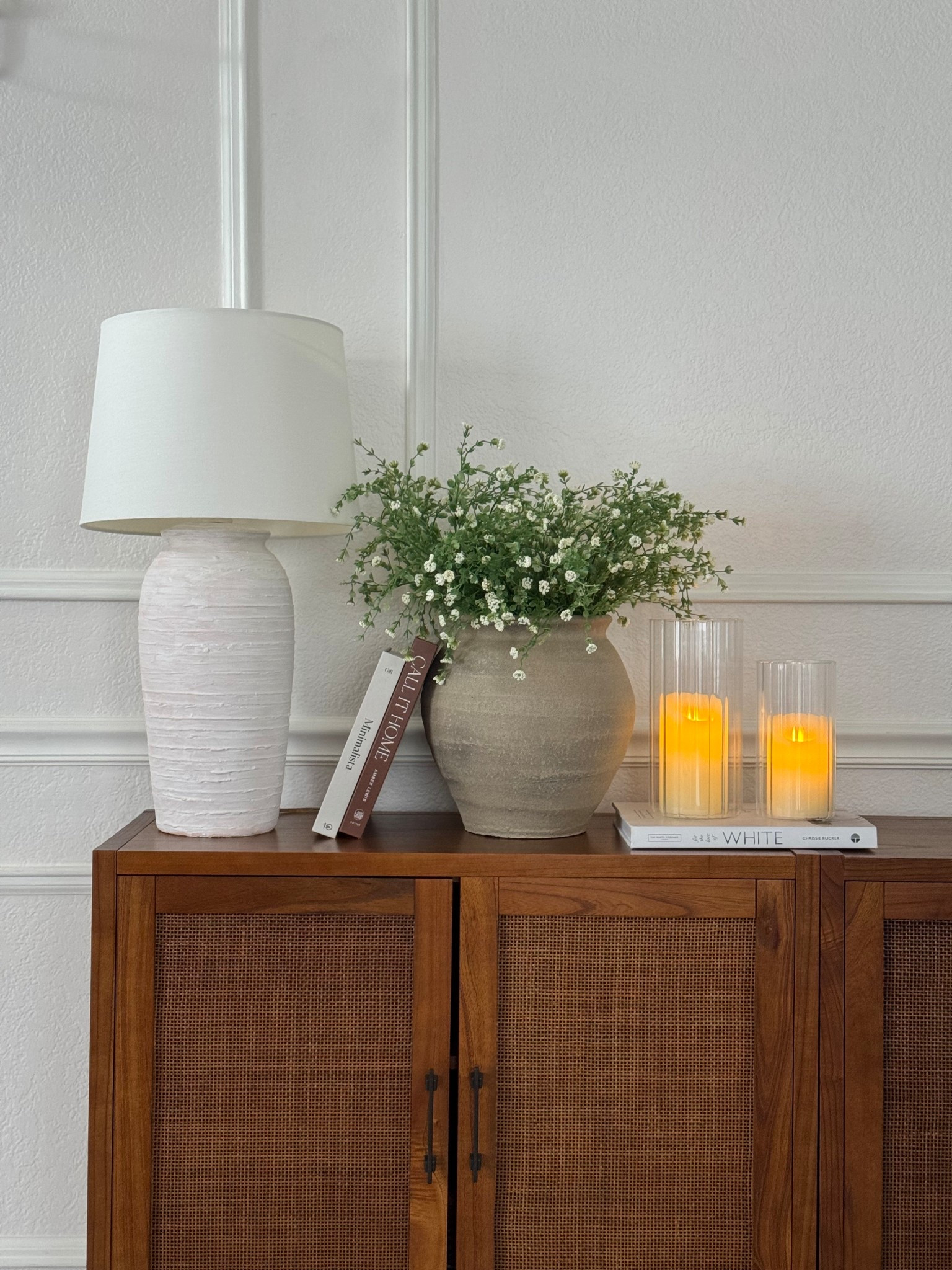 Wood storage cabinet! Flameless candles glass hurricane vases and decor books for the win! 

#LTKHome