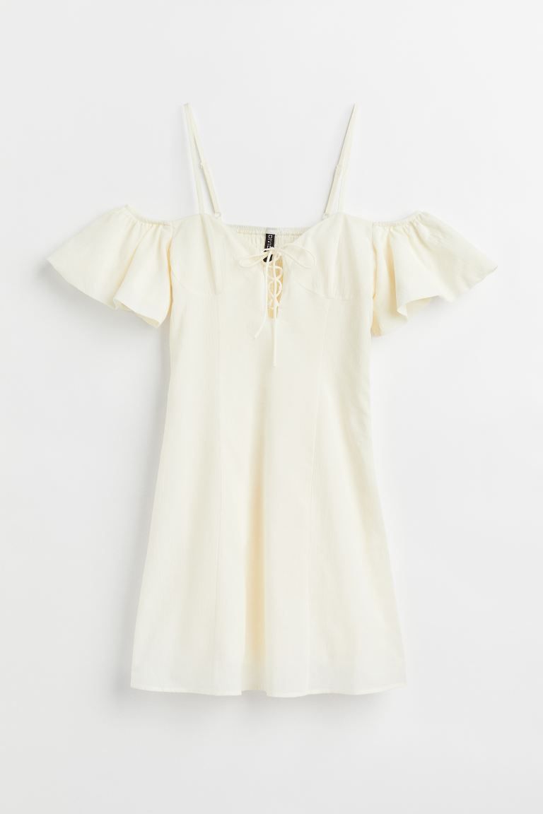 Short, open-shoulder dress in textured, woven cotton fabric. Narrow, adjustable shoulder straps, ... | H&M (US + CA)