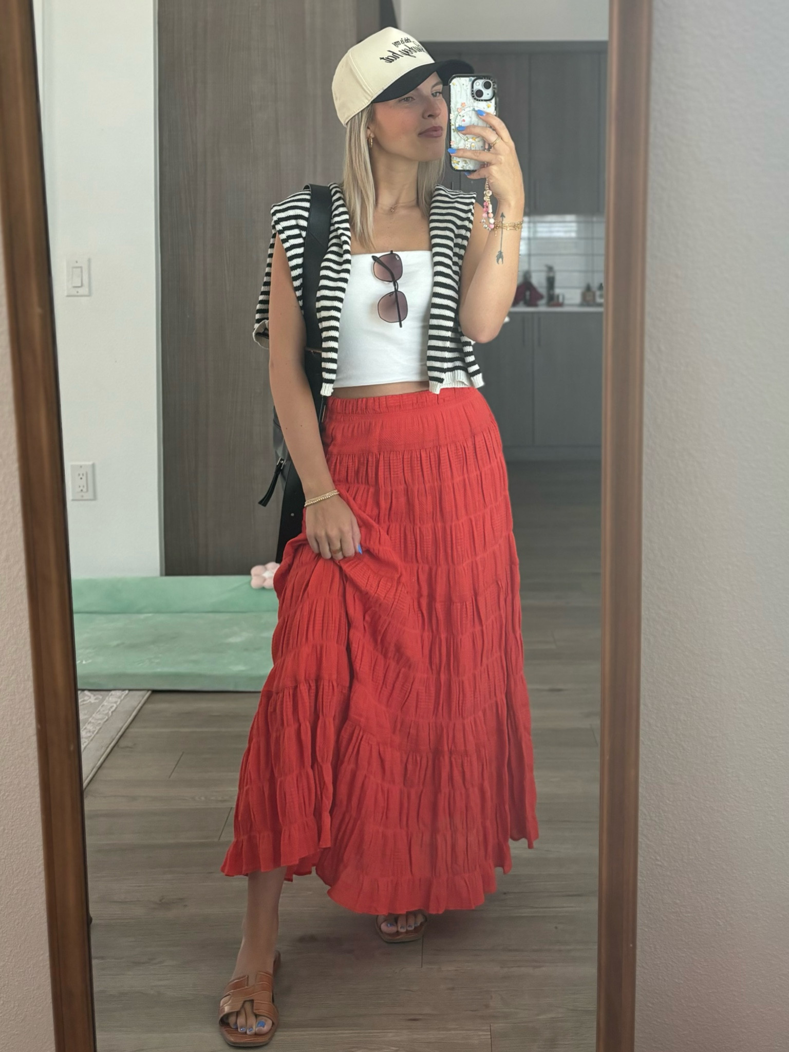 Red maxi skirt with a white tube top and sandals and a trucker hat with an Allsaints purse 

#LTKstyletip #LTKeurope #LTKSeasonal