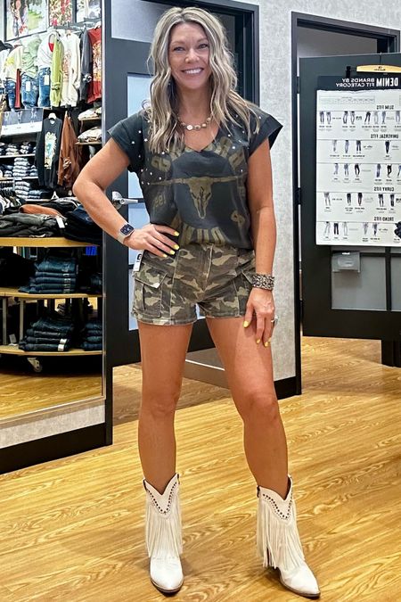 Camo + Cargo + side slit graphic band tee + stars - how many more trends can I get in to? 
Hidden cargo camo shorts are S/M/L sizing - and I’m typically a 25-26 but went with medium in the shorts because I like a bit of a relaxed feel with shorts. Soooo cute. Must have- these are going to sell out. And the tee- I’ll be boot-scooting to concerts in this one! Size small- oversized. All from Buckle . 
Posted similar boots. 
Buckle outfits. Concert outfit inspo. #buckledout 

#LTKSeasonal #LTKfindsunder100 #LTKstyletip