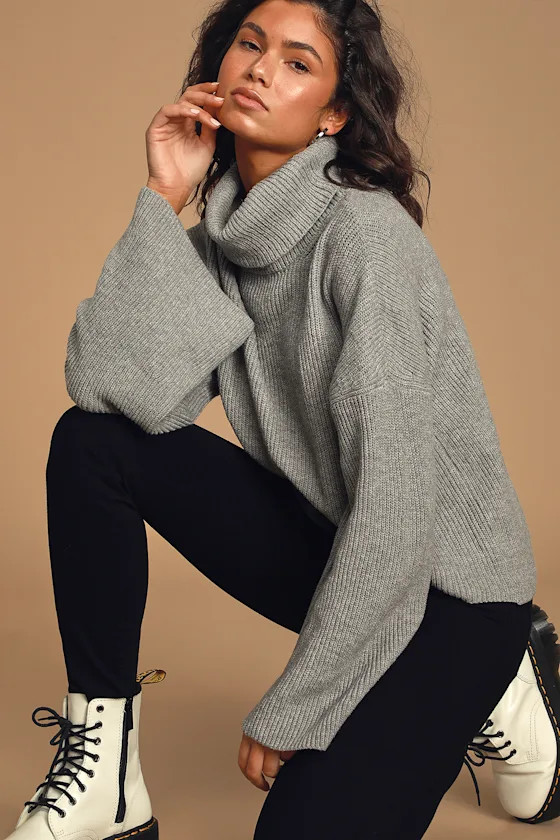 Woman in gray ribbed turtleneck sweater with leggings