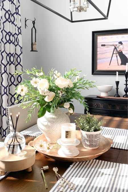 Spring styling with elegant black chandelier, beautiful white roses, Blue and white curtain panels, black cabinet on sale, Cosmo florals with greenery, favorite textured vase, beach print, black candleholders, candle accessories, wood tray, pedestal bowl, wood riser. Home decor accessories, interior styling. 

#LTKhome #LTKunder50 #LTKsalealert