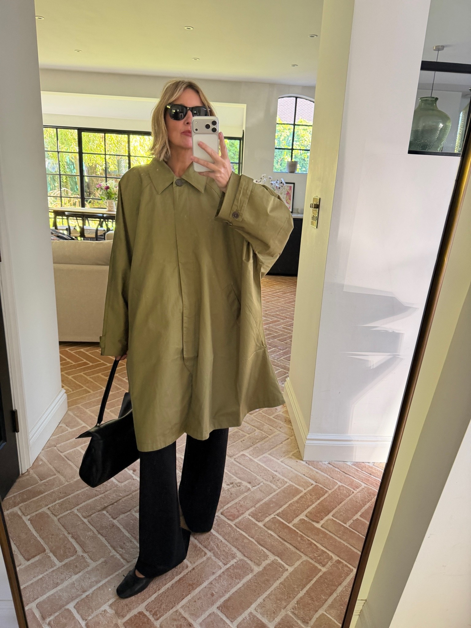 Trench coat season 

oversized khaki mac, olive trench coat, cocoon shape coat, statement raincoat, black wide leg trousers, black ballet flats, black leather shoulder bag, black square sunglasses, autumn transitional dressing, oversized outerwear, minimalist style, elevated basics, quiet luxury, neutral color palette, monochrome styling, mirror selfie ootd, ltkstyletip, ltkseasonal, ltkfindsunder100, ltkitbag

#LTKFashionMonth #LTKtravel #LTKeurope
