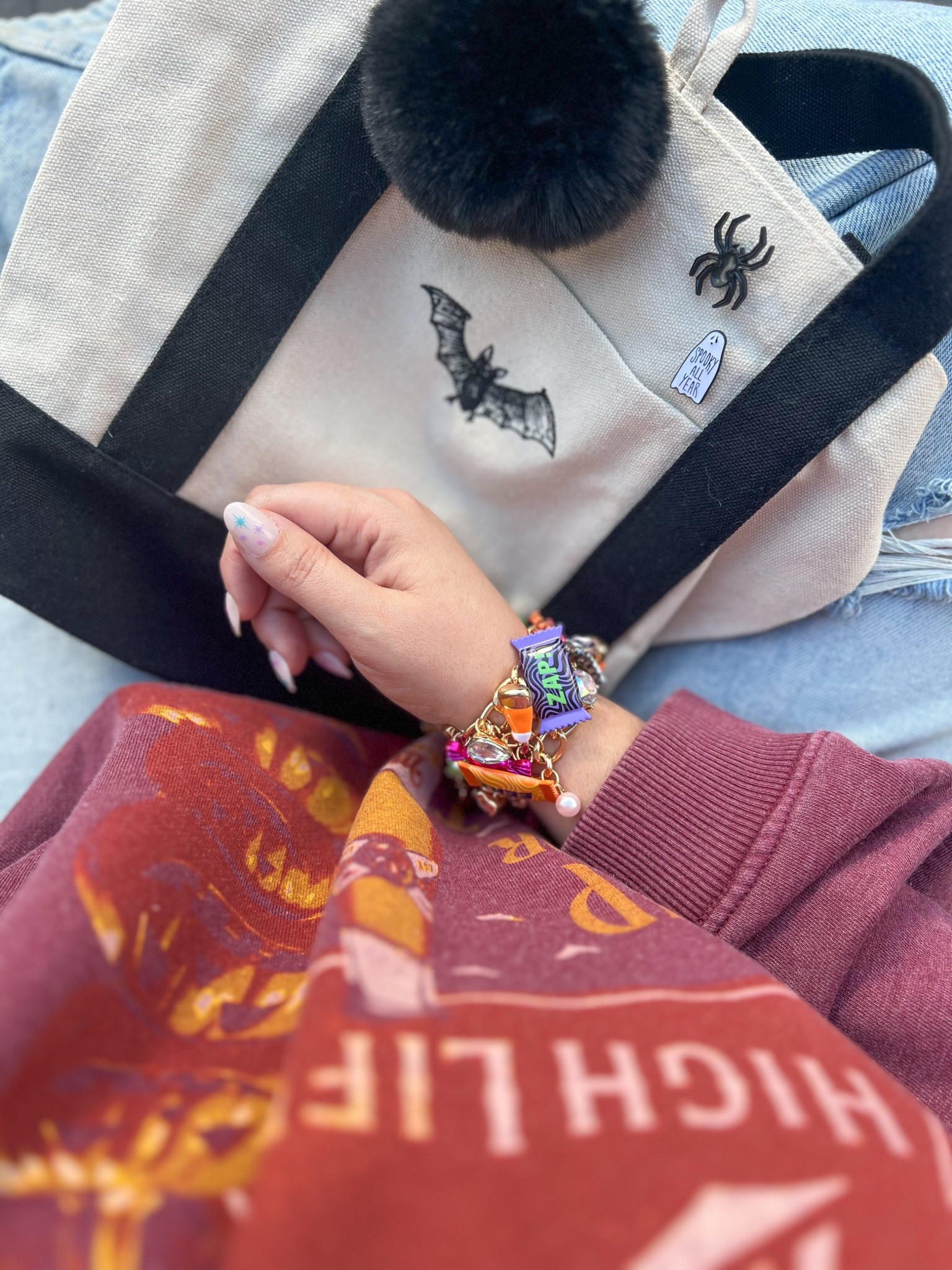 This sweatshirt has been on repeat since the moment I bought it (full price, might I add 🤣) - and now it’s on freaking sale! RUNNNN! PS. This bracelet is my whole personality. 🍬🦇

#LTKHalloween #LTKMidsize #LTKFamily
