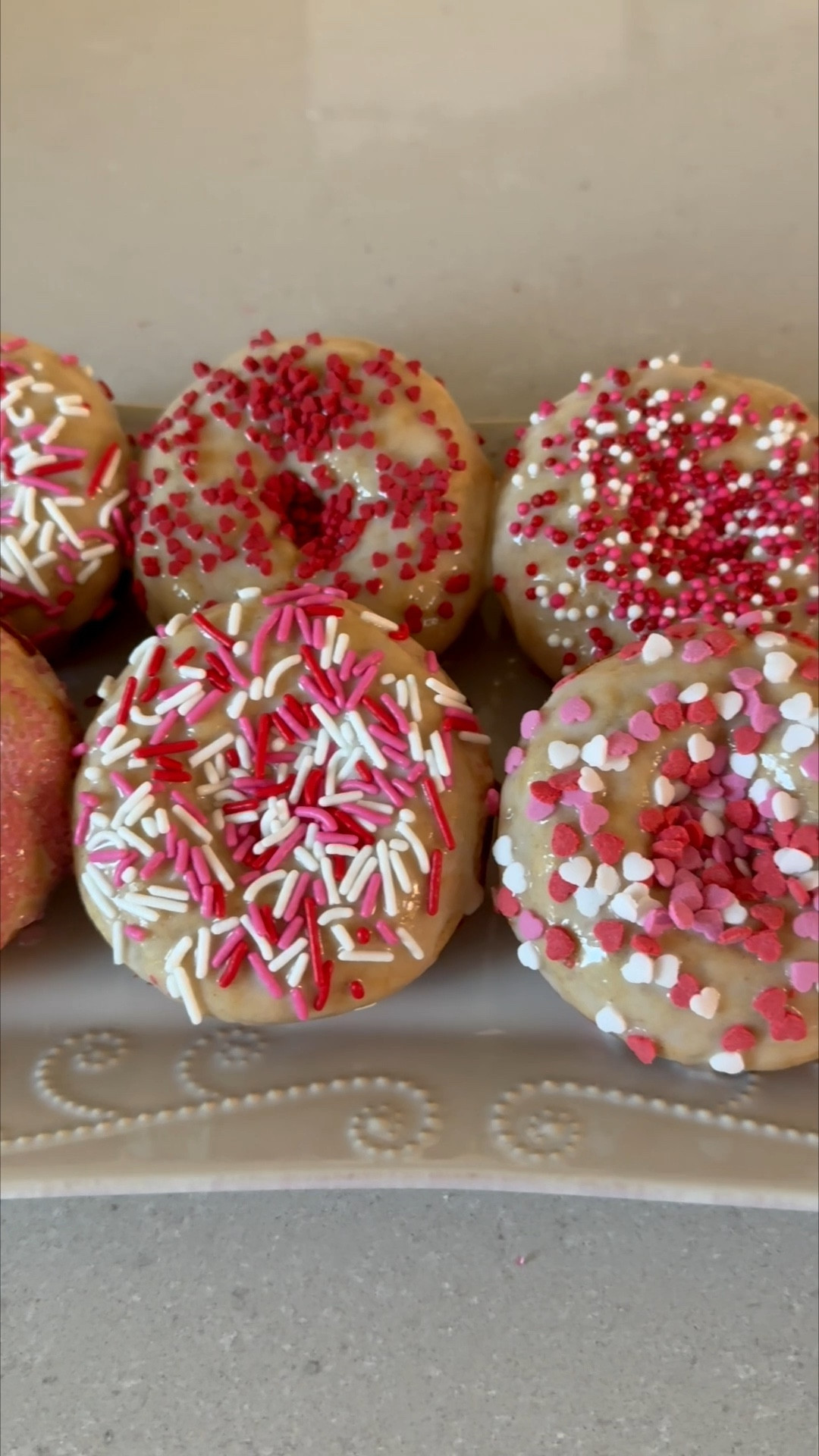 Make Valentine’s Day Donuts with me ❤️💗 This recipe has become favorite in our house! The kids love them 👌 

Donuts
• 1/2 cup of plain Greek yogurt 
• 1/2 cup of milk 
• 1/4 cup of unsalted butter (melted and cooled)
• 1 egg (lightly beaten)
• 1 teaspoon of vanilla extract 
• 1 1/2 cups of all purpose flour 
• 1/3 cup of sugar 
• 1 teaspoon of cinnamon 
• 1 teaspoon of baking powder 
• 1/2 teaspoon of baking soda 
• 1/4 teaspoon of salt 
Glaze 
• 1 cup of powdered sugar 
• 4-5 tsp of milk
• 1/2 tsp of vanilla extract 

(Topping option) 
Cinnamon Sugar Topping 
• 1/4 cup of sugar
• 1/2 teaspoon of cinnamon 
• 2 tablespoons of melted butter 

Preheat the oven to 375 degrees F and grease two 6-cup donut pans with nonstick spray.
Add the yogurt, milk, butter, egg, and vanilla to a medium bowl. Whisk to combine well.
Add the flour, sugar, cinnamon, baking powder, baking soda, and salt to the bowl. Whisk to combine into a thick batter.
Use ¼ cup batter in each prepared donut spot.
Bake for 12-14 minutes, or until puffed up, golden brown, and a cake tester or toothpick inserted into the center of a donut comes out clean.
Remove from oven and let cool for a minute or two. Run a knife around the edges to loosen, as needed, then transfer donuts to a wire rack to cool completely.
In a small bowl mix powdered sugar, milk and vanilla and whisk them together. Dip the tops of the donuts to cover with glaze and then add your sprinkles! 
Optional: Stir the sugar and cinnamon together in a small bowl. Dip the top of each donut first in the melted butter, then in the cinnamon-sugar mixture. This makes them taste just like a cake donut! 
(Recipe from Yummy Toddler Food) 

Homemade donuts, Amazon, kids breakfast, donut molds, breakfast ideas, kids meals, Valentine’s Day treat, Valentine’s Day breakfast, kids Valentine’s Day

#LTKmomlife #LTKdayinmylife #LTKfoodie