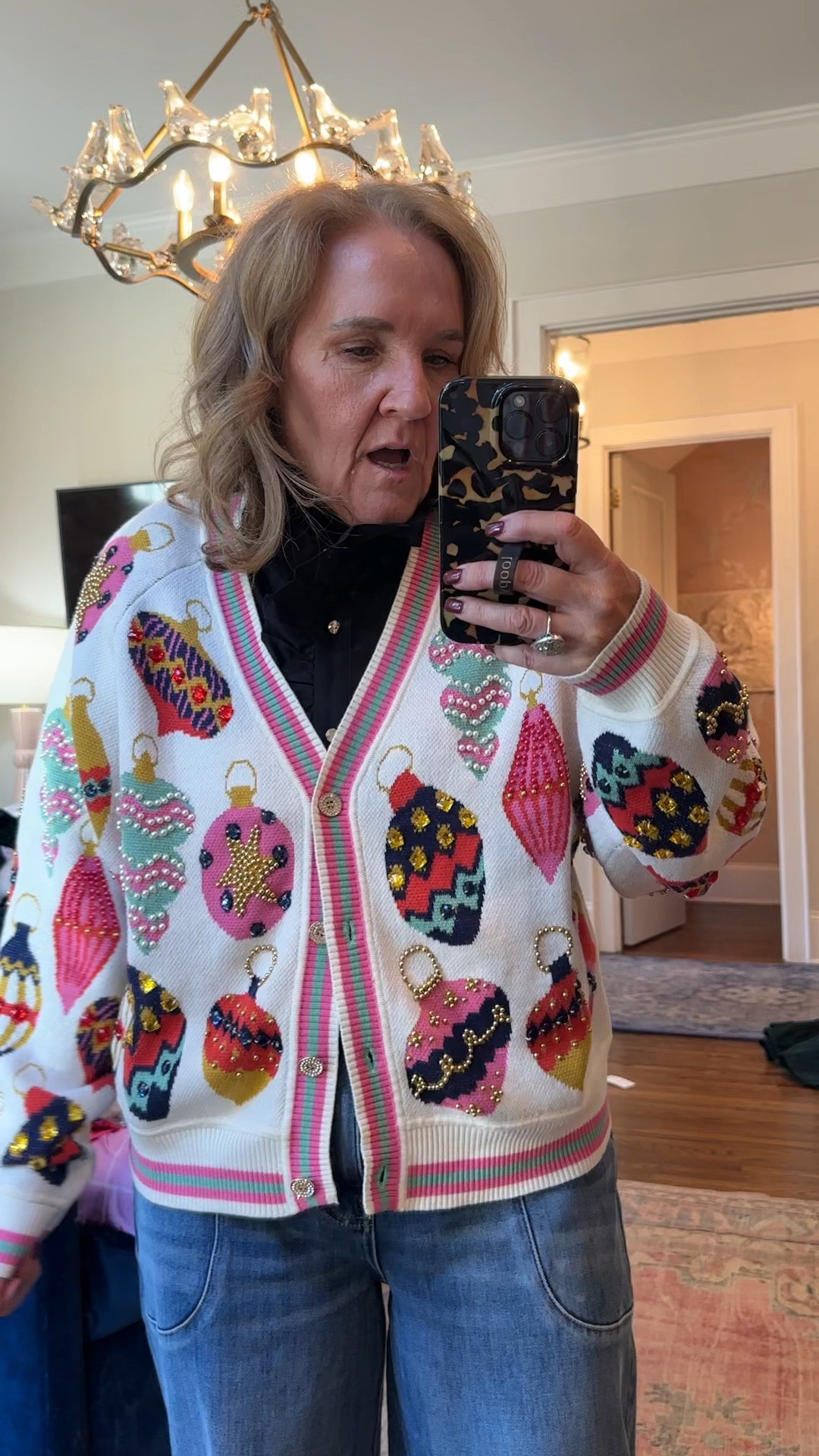 Found another link for this sweater since it already sold out at Avara! 

I prob wouldn’t wear it with this blouse, I was just trying it on. I like it worn as a V-neck, or I would wear a colorful tea underneath. It is oversized. I am wearing a size small.

The black top I’m wearing is lovely for dressing up or dressing down with jeans. I am wearing a large. You can order your regular size. 

Ugly Sweater sequin sweater ornament sweater, queen sparkles, cardigan, cardigan, Christmas sweater

#LTKParties #LTKOver40 #LTKHoliday