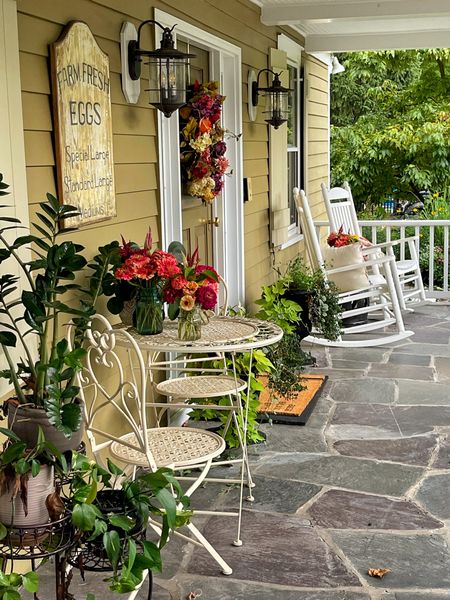 Porch decorating ideas, outdoor living, porch rocker, porch swing, bistro table and chairs, wreath, houseplants

#LTKSeasonal #LTKhome