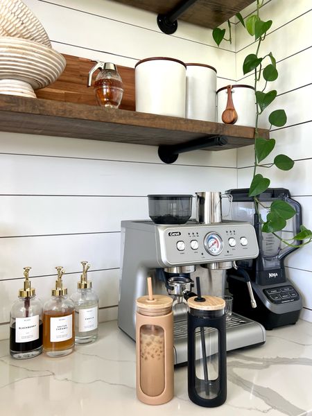 In home coffee bar coffee station espresso machine coffee maker blender open shelving canisters flour and sugar syrup bottles with labels honey and syrup dispenser portable iced coffee cups tumblers with silicone wood bowls charcuterie board kitchen home decor shelf styling countertop accents and accessories amazon and target finds and faves

#LTKstyletip #LTKhome #LTKFind
