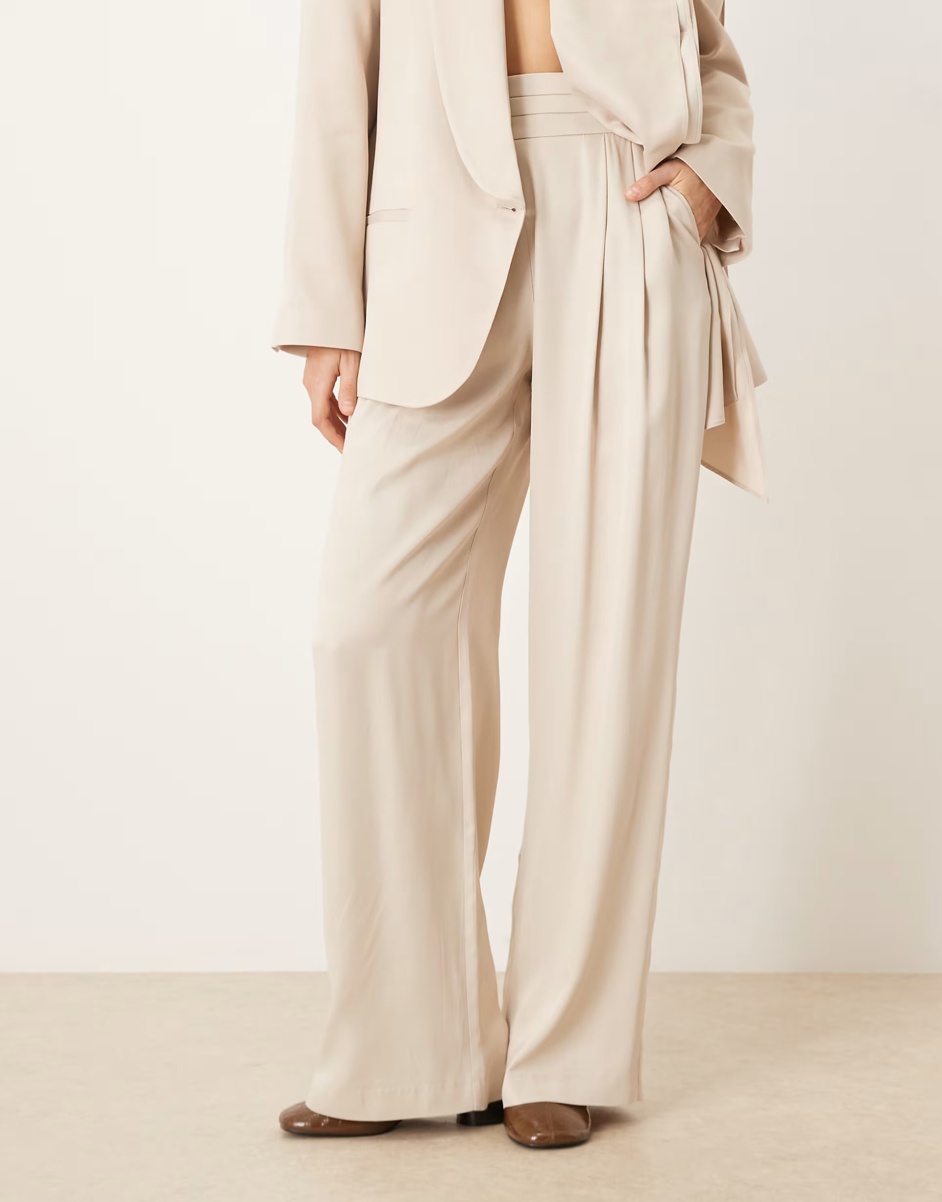ASOS DESIGN tailored wide leg satin trousers with deep pleat waistband in cream | ASOS (Global)