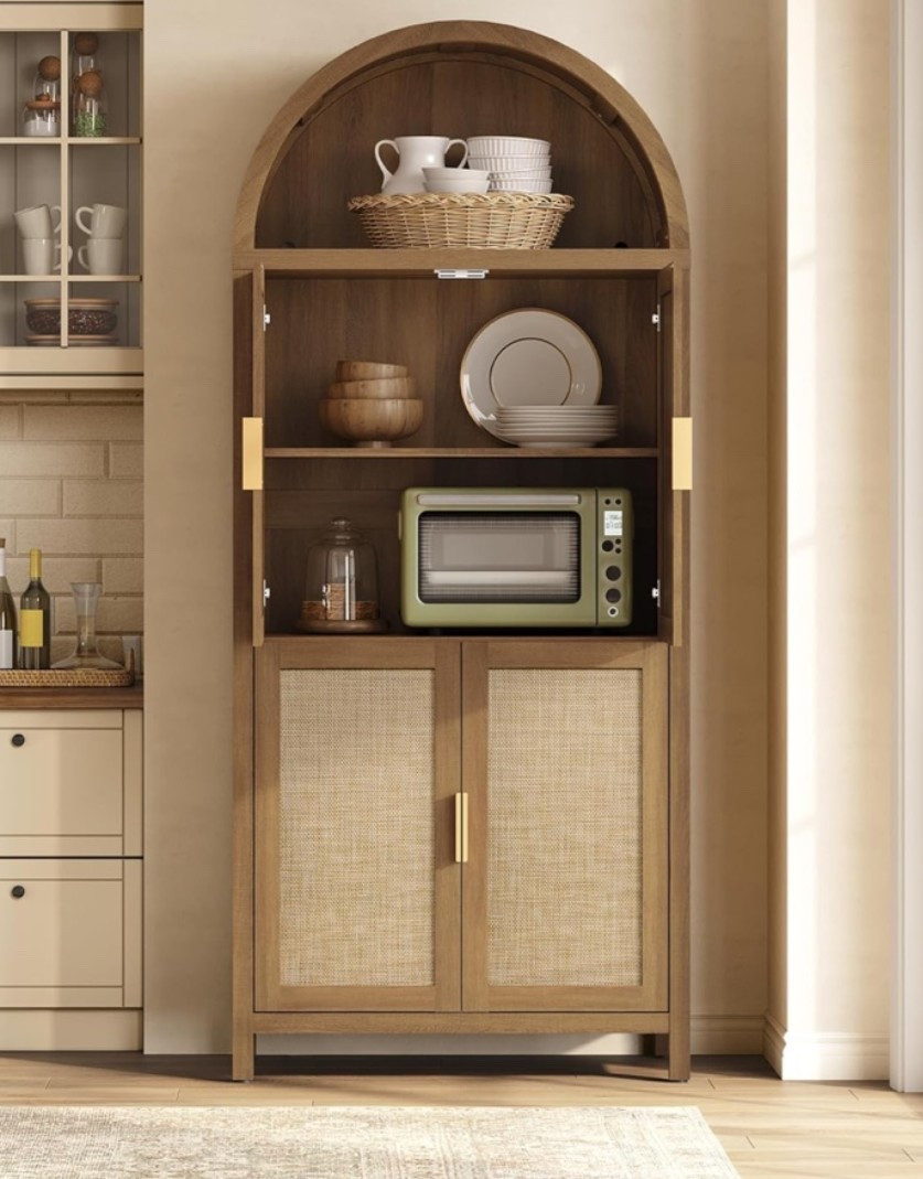 Tall arched pantry cabinet with that warm boho farmhouse charm that makes storage feel beautiful instead of bulky. 🌿 Perfect for a kitchen, dining room, living room, pantry wall, coffee bar, or entryway when you need extra storage that still looks styled and intentional. The reclaimed caramel oak finish, rattan doors, arched shape, and adjustable shelves give it that cozy designer look while keeping dishes, linens, pantry items, or decor tucked away. 

Add this cabinet if your home needs storage that feels warm, functional, and pretty enough to leave on display. ✨

#LTKHome #LTKU #LTKOver40