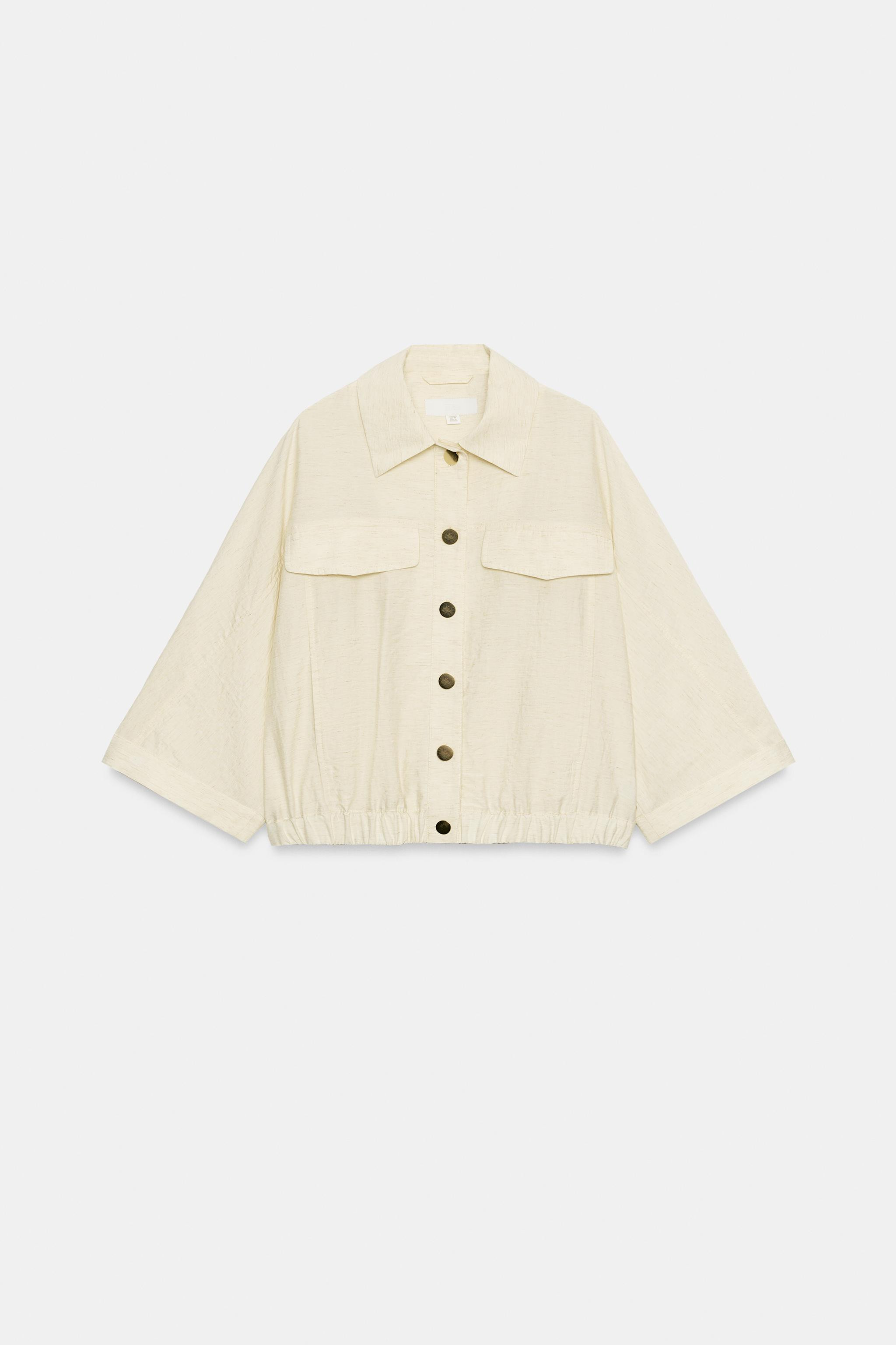 Lapel collar blouse with below-the-elbow length sleeves featuring a tab and button. Front flap de... | Zara US