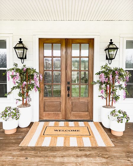 Spring Front Porch!! Loving these wisteria trees! Use BRUNOANDLIBBY for 30% off at nearly natural! Jute rug is 4x6. Front porch and front door decor large white planter trending viral home decor pottery barn dupe look a like look for less artificial faux plants trees flowers florals greenery modern farmhouse southern porch lantern, outdoor light fixtures, wall sconces lighting silk faux flowers d geraniums, hydrangeas kalanchoes pink florals jute rug scatter rug welcome mat doormat, double layered