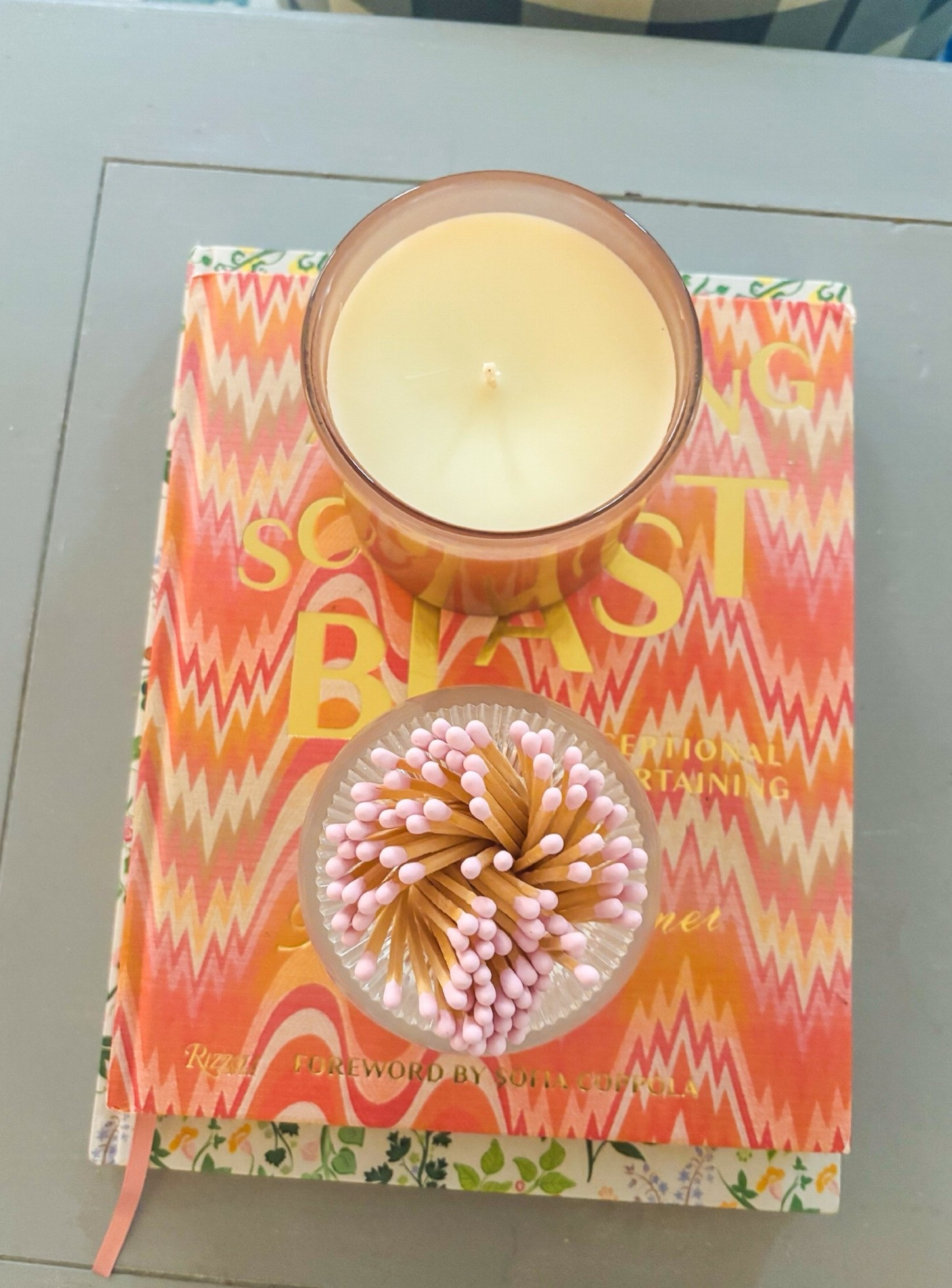 Elite combo: a @Tart By Taylor match striker, a LAFCO candle, and colorful coffee table books.

#LTKHome