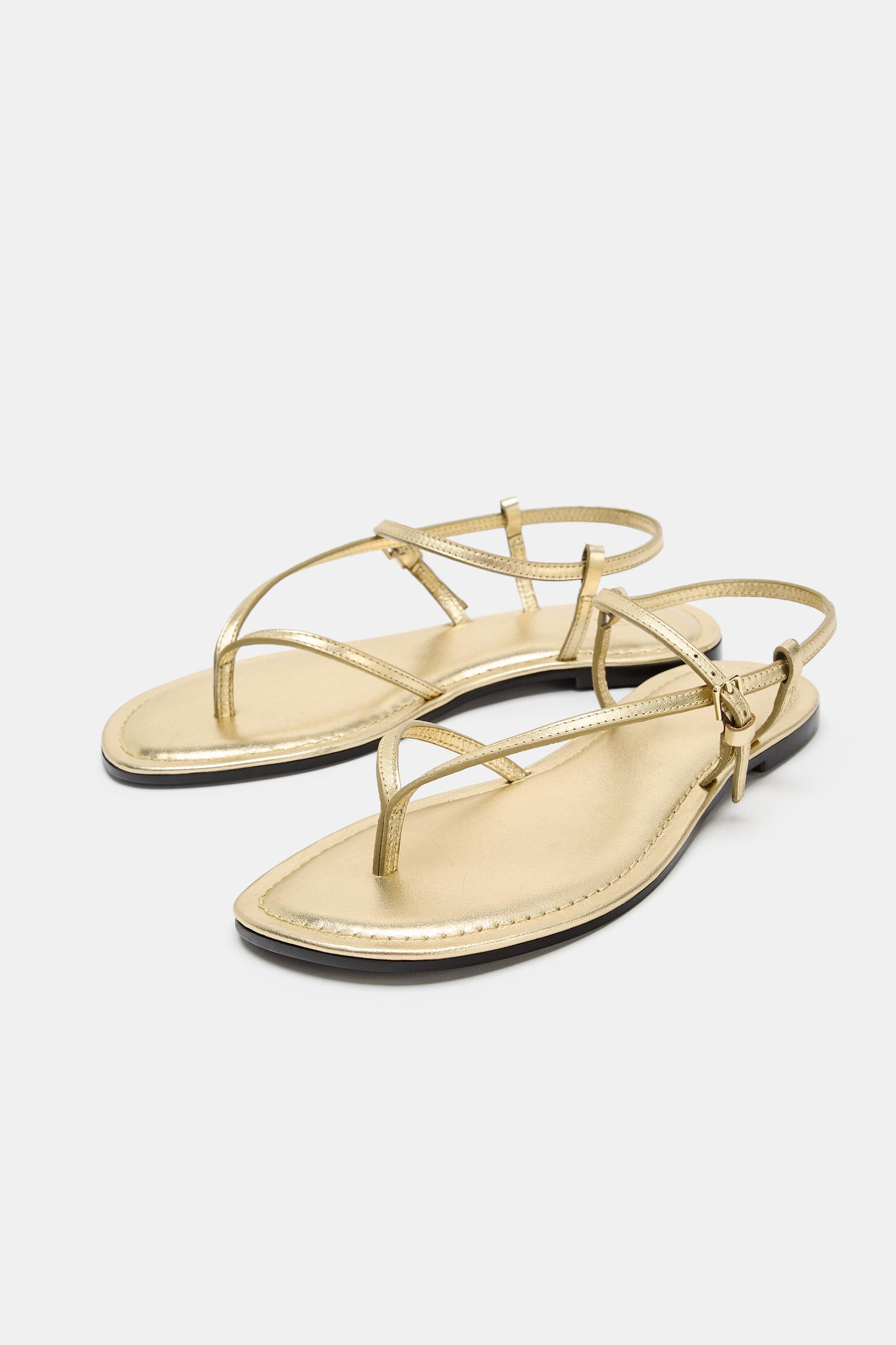Model height: 181 cmFlat leather sandals. Metallic-effect top. Front strap with toe divider. Buck... | Zara US