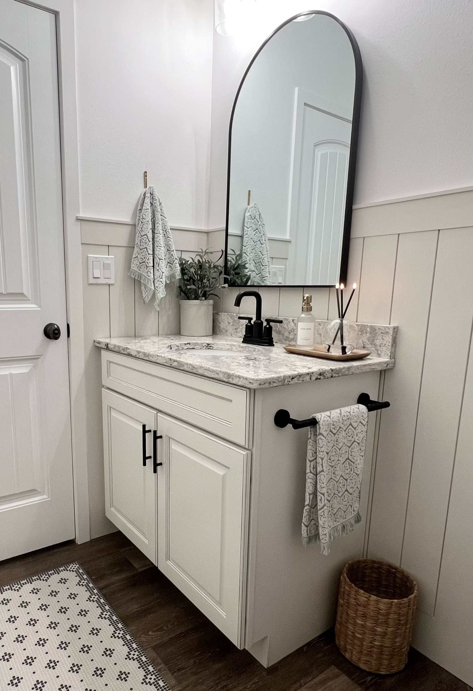 Bathroom / white bathroom / soap dispenser / hand towels / black fixtures / arched mirror / black mirror / black faucet / everlasting candle / wood tray / black hardware / seagrass basket / waste basket / target home / Amazon home 

#LTKhome #LTKunder100 #LTKunder50