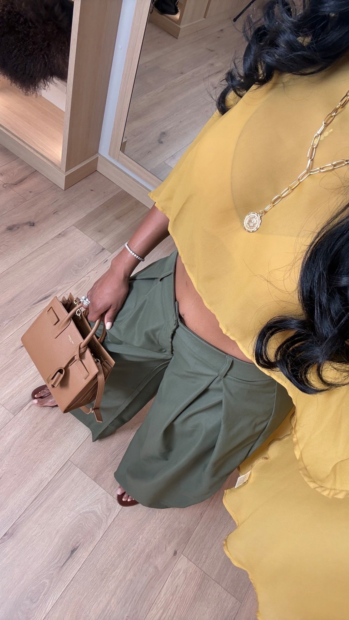 This color combo is such a standout — soft, elevated, and effortlessly chic without feeling overdone. The flowy yellow top paired with tailored olive trousers gives that polished-but-relaxed vibe that works season after season.

This is one of those outfits where every piece earns its place. The trousers are a wardrobe staple that style endlessly, and the designer-inspired bag instantly elevates the look. When you rewear these pieces across multiple outfits, the cost per wear drops fast — a smart long-term shopping strategy that still looks luxe.

Perfect for brunch dates, vacation dinners, daytime events, casual workdays, or anytime you want an elevated neutral moment with a pop of color.

📏 Sizing & fit details:  
Top: Size Small  
Pants: 27 Long  
Shoes: True to size  
Bag: Structured mini/top-handle style

Measurements: 5'4", 138 lbs, 34D bust, 27" waist, 40" hips

This outfit works beautifully for chic summer outfits, elevated casual looks, vacation-ready styling, neutral outfits with color, capsule wardrobe staples, designer-inspired handbags, polished everyday wear, and effortless feminine styling.

Follow me on Instagram and YouTube @kirasfashionfinds 

#LTKootd #LTKActive