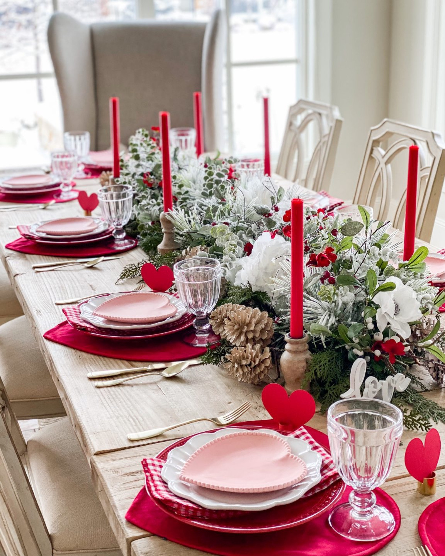I love to create layers in my the place settings. For this particular tablescape, I used a red heart placemat, a red beaded dinner plate, white scalloped salad plate, and a pink beaded heart dessert plate. I then added a red and white checkered napkin under the white plate to create some contrast.

#LTKHome #LTKParties #LTKSeasonal
