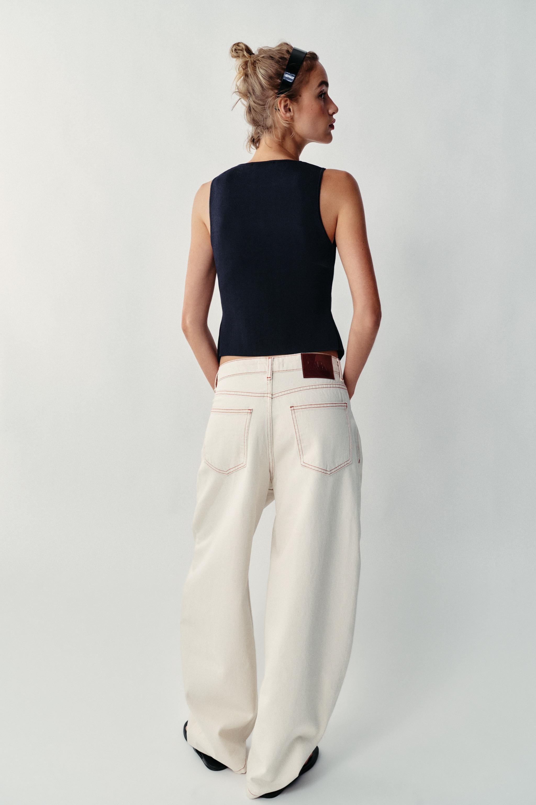 Round neck, sleeveless top. Front closure and asymmetric hem. | Zara US