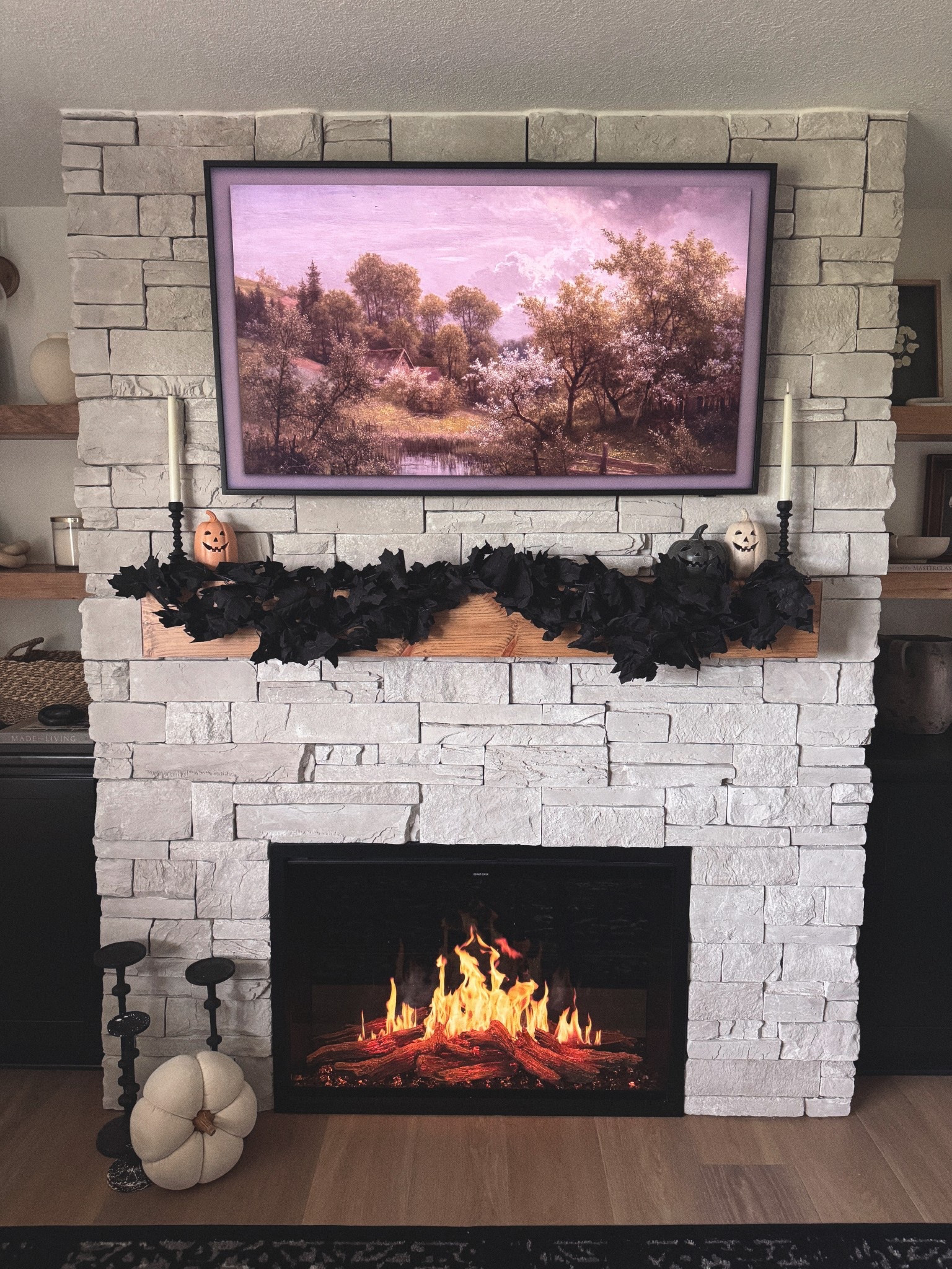 Spooky but make it cozy 🖤✨ Styled our fireplace for Halloween with simple touches—black garland, ghost pumpkins, and little pops of spooky without losing the warmth of fall. Shop the exact pieces (and dupes!) right here so you can recreate the look for your own mantel. 🎃🕯️ #LTKhome #LTKholiday #LTKseasonal #LTKfall #HalloweenDecor #FireplaceDecor #MantelStyling