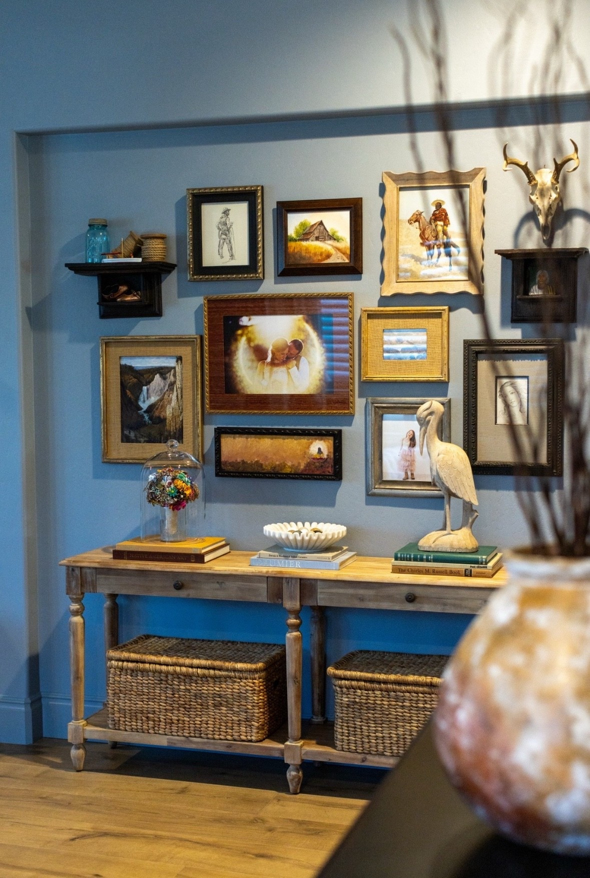 The perfect console table accessories include your favorite art, lidded storage, and some unique objects. This area is located just off our entry and it is one of my favorite styled corners of my home. The gallery wall features mismatched frames with a mixture of real oil on canvas art, giclee prints, and family photos. I also incorporated vintage coffee table books from a used book store, a wooden bird figurine I picked up at an antique store, and my favorite lidded baskets to hold all my interior design samples. I hope this inspires you to create a collected and loved corner in your home 🤎

lidded basket | vintage art prints | vintage coffee table books | gallery wall | console table styling | World Market | Pottery Barn | Etsy 

#LTKSaleAlert #LTKStyleTip #LTKHome