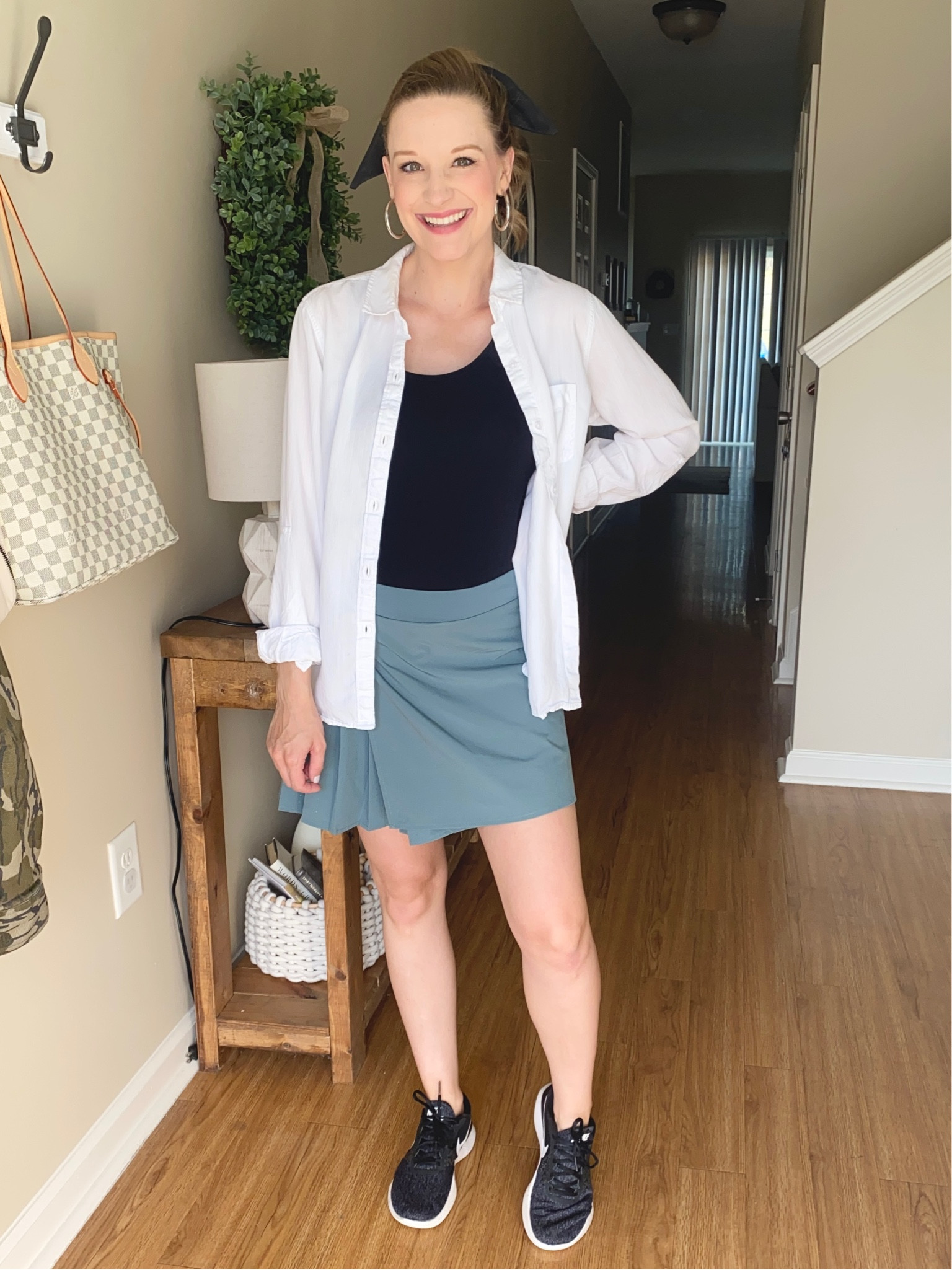 Walmart athletic skirt paired with a black tank top and a white button front shirt! Throw on some black Nike tennis shoes!! 