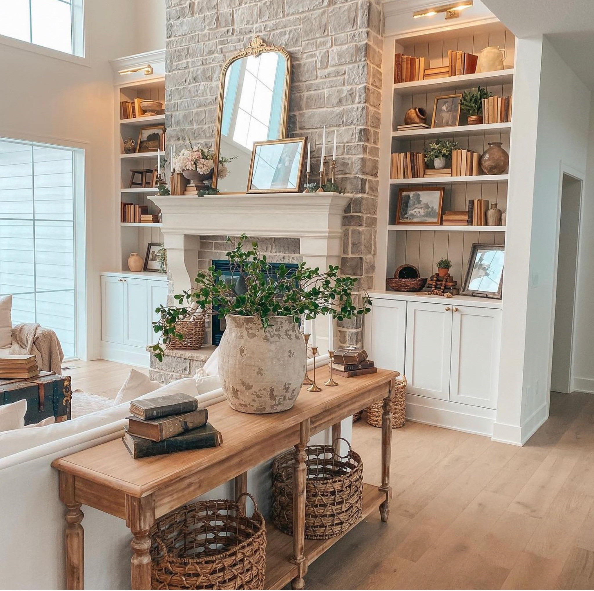 Shop this space. Console table, Pottery Barn vase, stems, faux greenery, vintage mirror, vintage books, Pottery Barn sofas. 
Home decor. Shelf decor. Vases.

#LTKstyletip #LTKFind #LTKhome