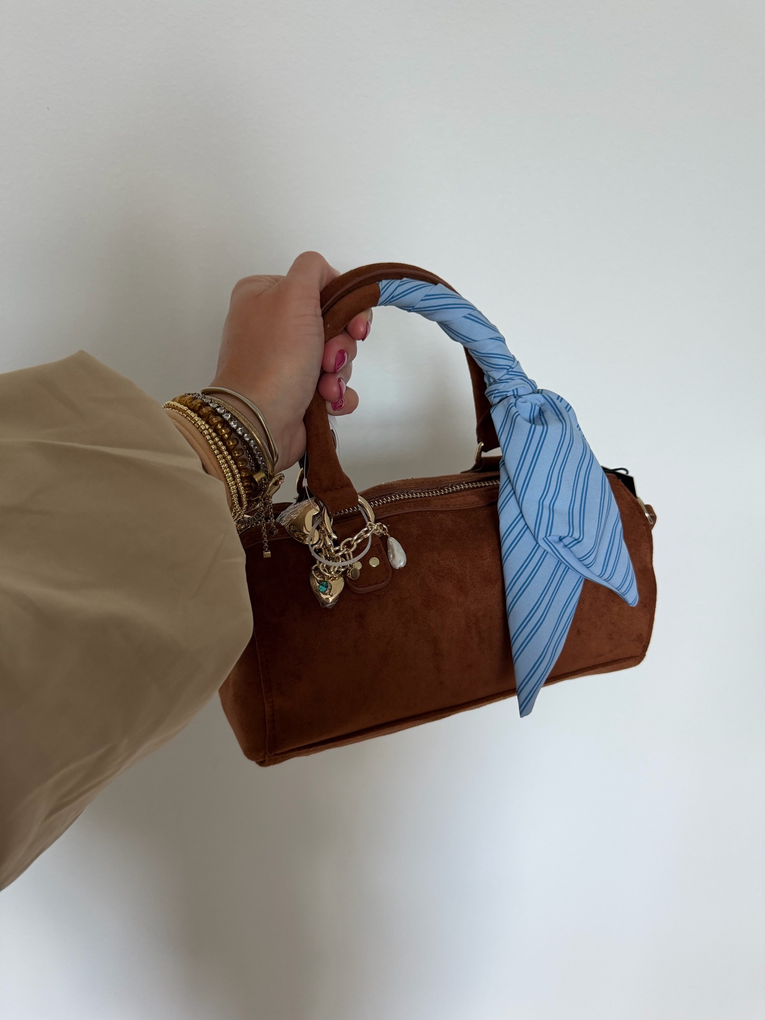 The Madde NYC Small Top Zip Faux Suede Handbag—crafted in a soft faux suede for a chic look, this baguette-silhouette handbag tucks neatly under your arm like it’s meant to be there. Running late? Clip on the crossbody strap and go hands-free? Feeling stylish? Add the scarf, let the keychains swing, and your look is now complete. With a top zip to secure the essentials, this handbag is a versatile choice for any type of day.

#LTKootd #LTKSeasonal #LTKSaleAlert