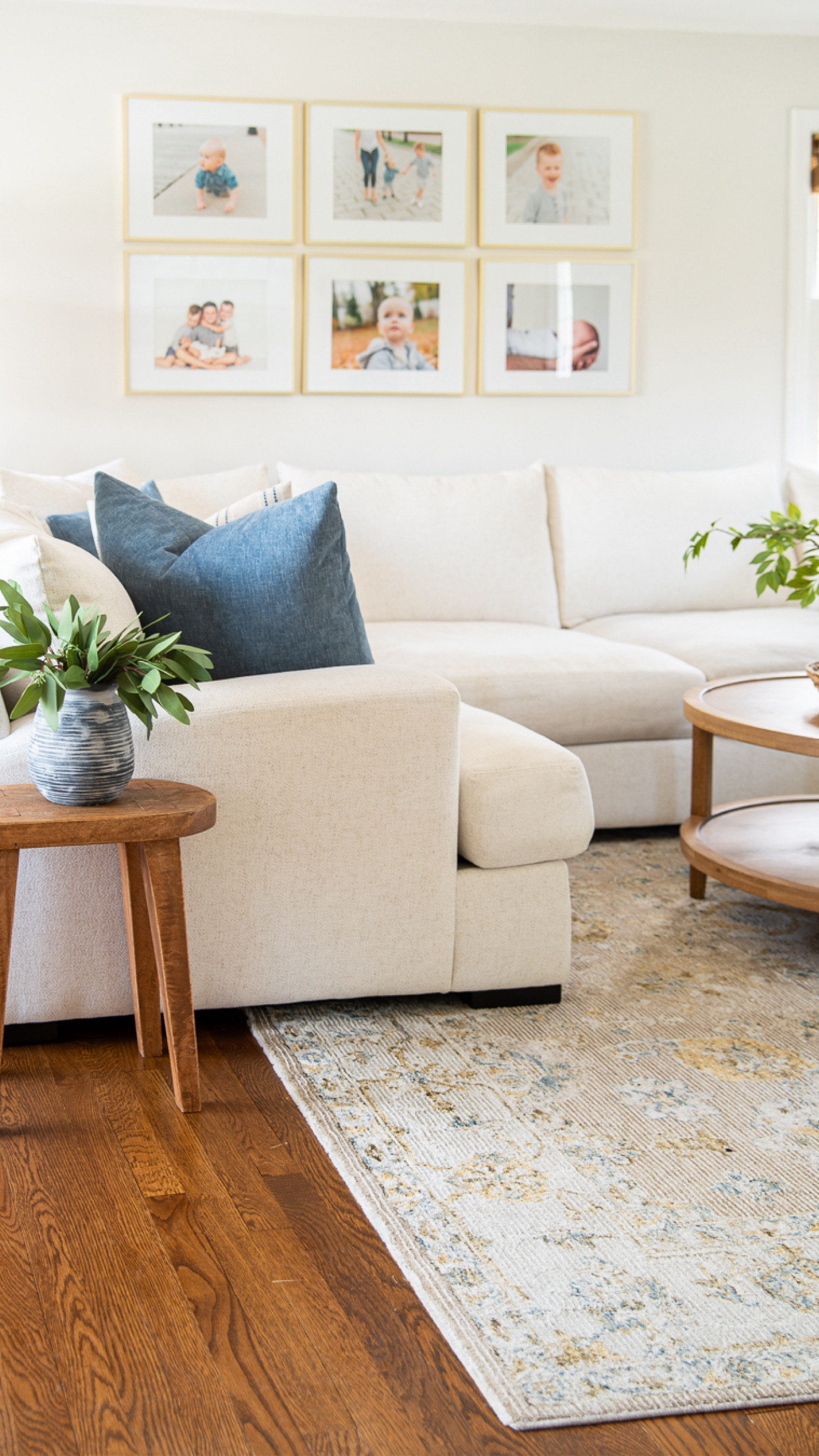 Coastal style living room with white sofa, small side table, artificial plants, large area rug, blue throw pillows, round wooden coffee table, and more home decor

#LTKHome #LTKFamily